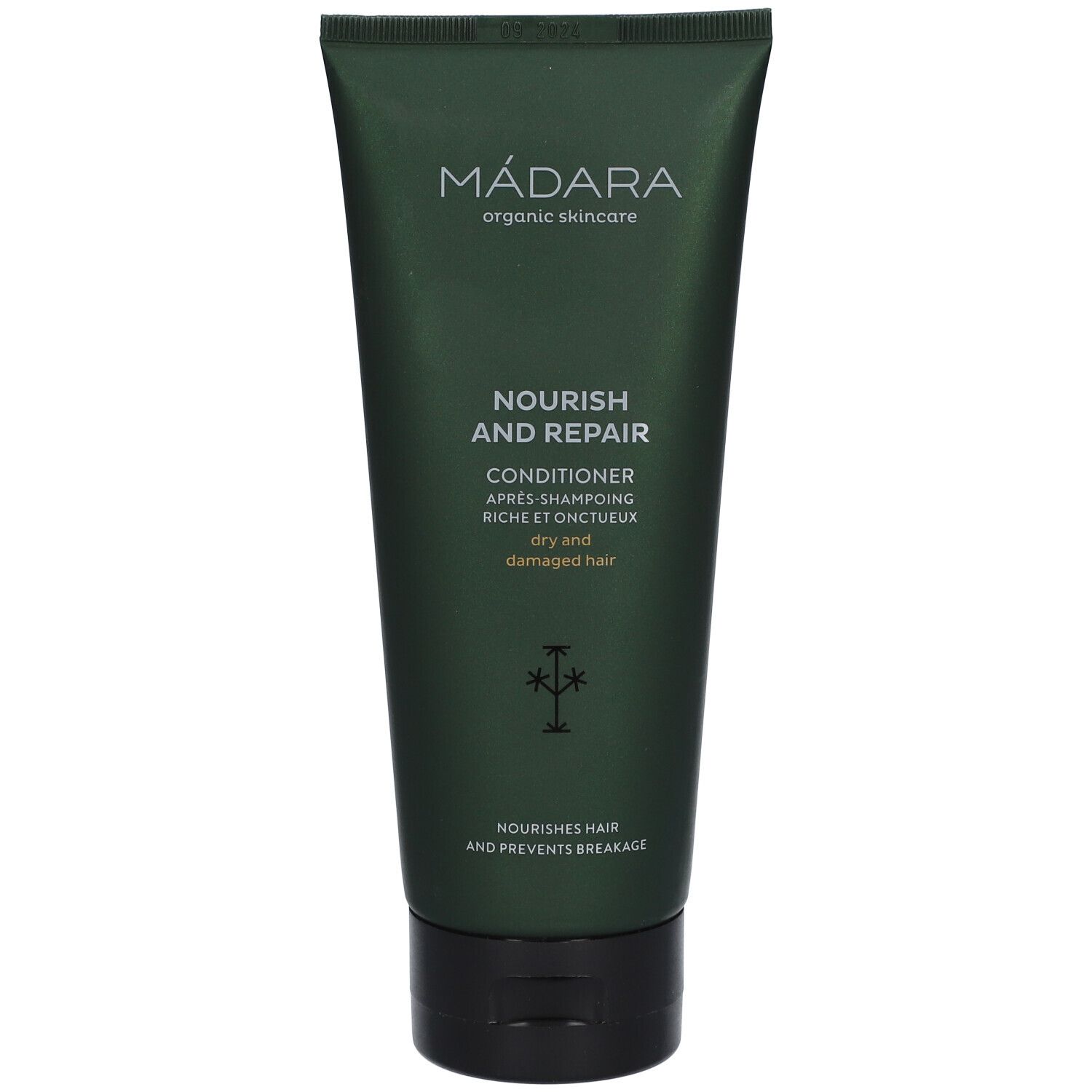 Tube vert MÁDARA, Conditioner Nourish and Repair pour cheveux secs et abîmés. Inscription et logo.