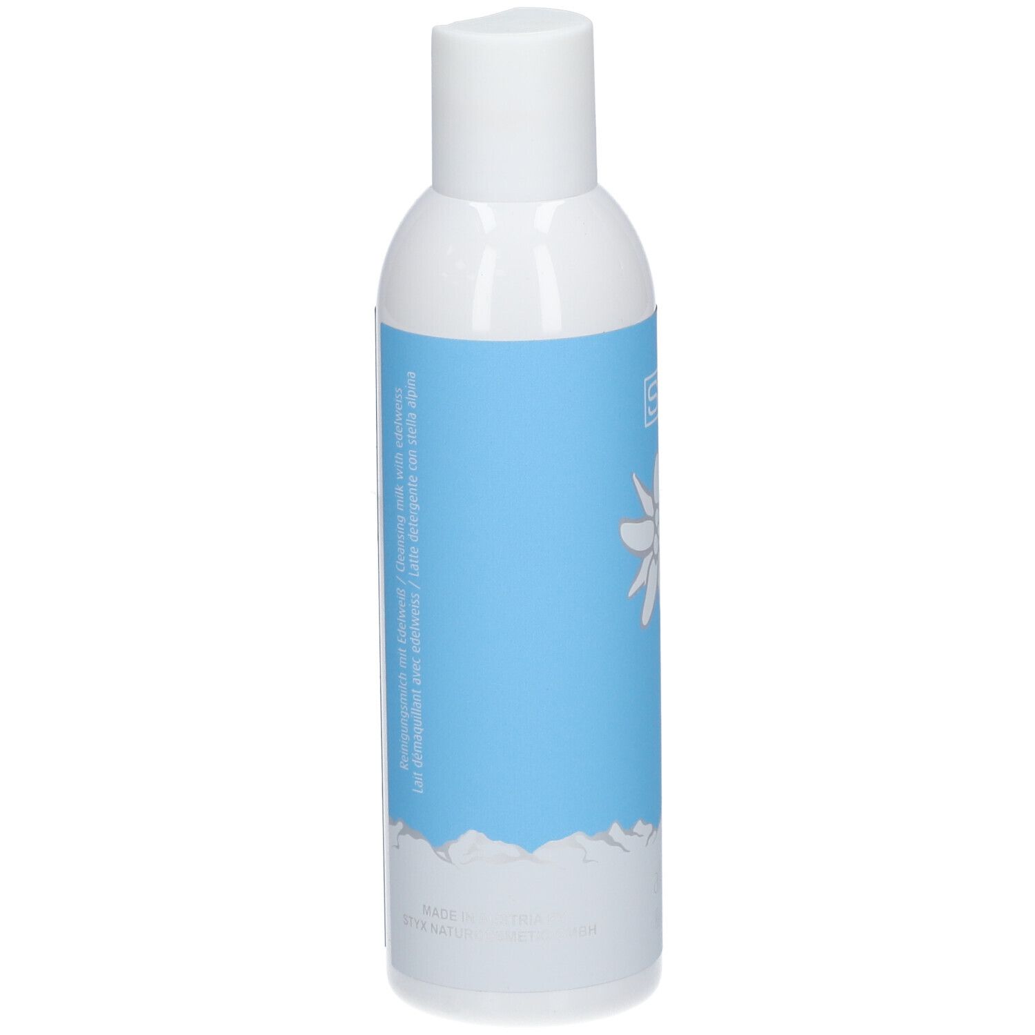 Dos d'un flacon blanc avec étiquette bleue. Texte: indications, ingrédients, fabricant. Motif montagne en bas.