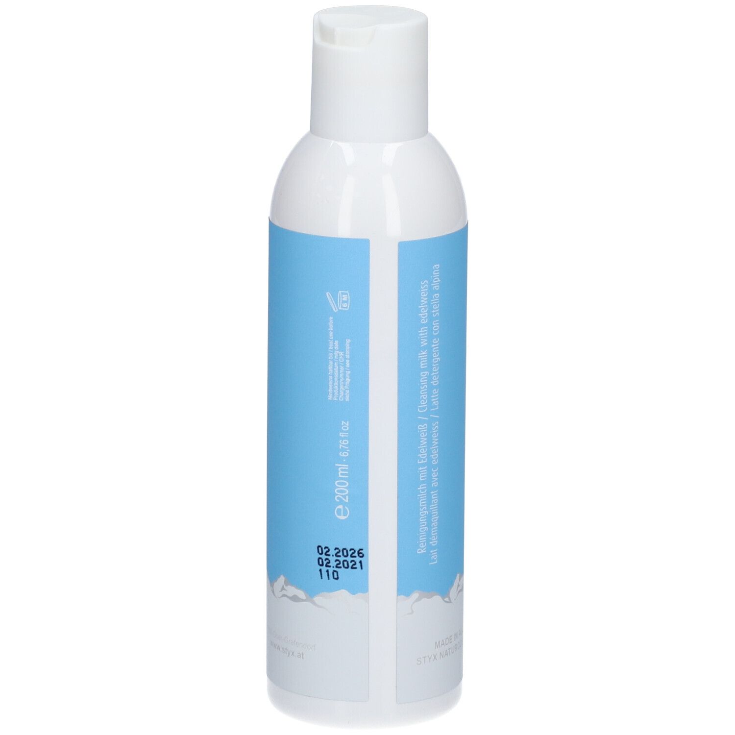 Flacon blanc avec étiquette bleue. Texte: 200ml, date de péremption, numéro de lot. Motif montagne en bas.