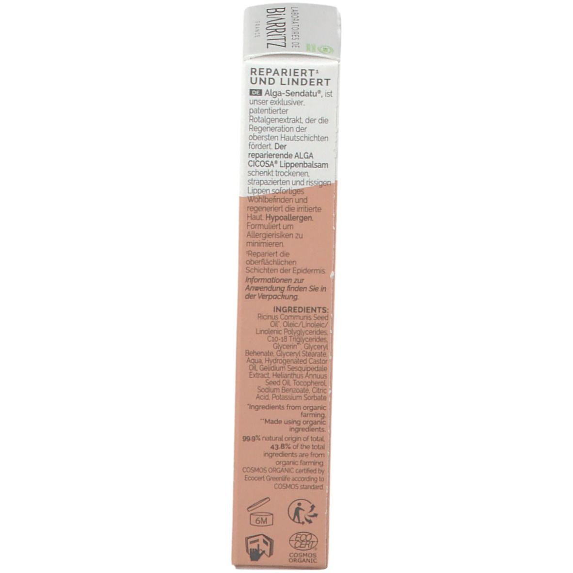 Dos de l'emballage du baume à lèvres. Texte avec ingrédients et informations. Blanc/rose. Label bio.