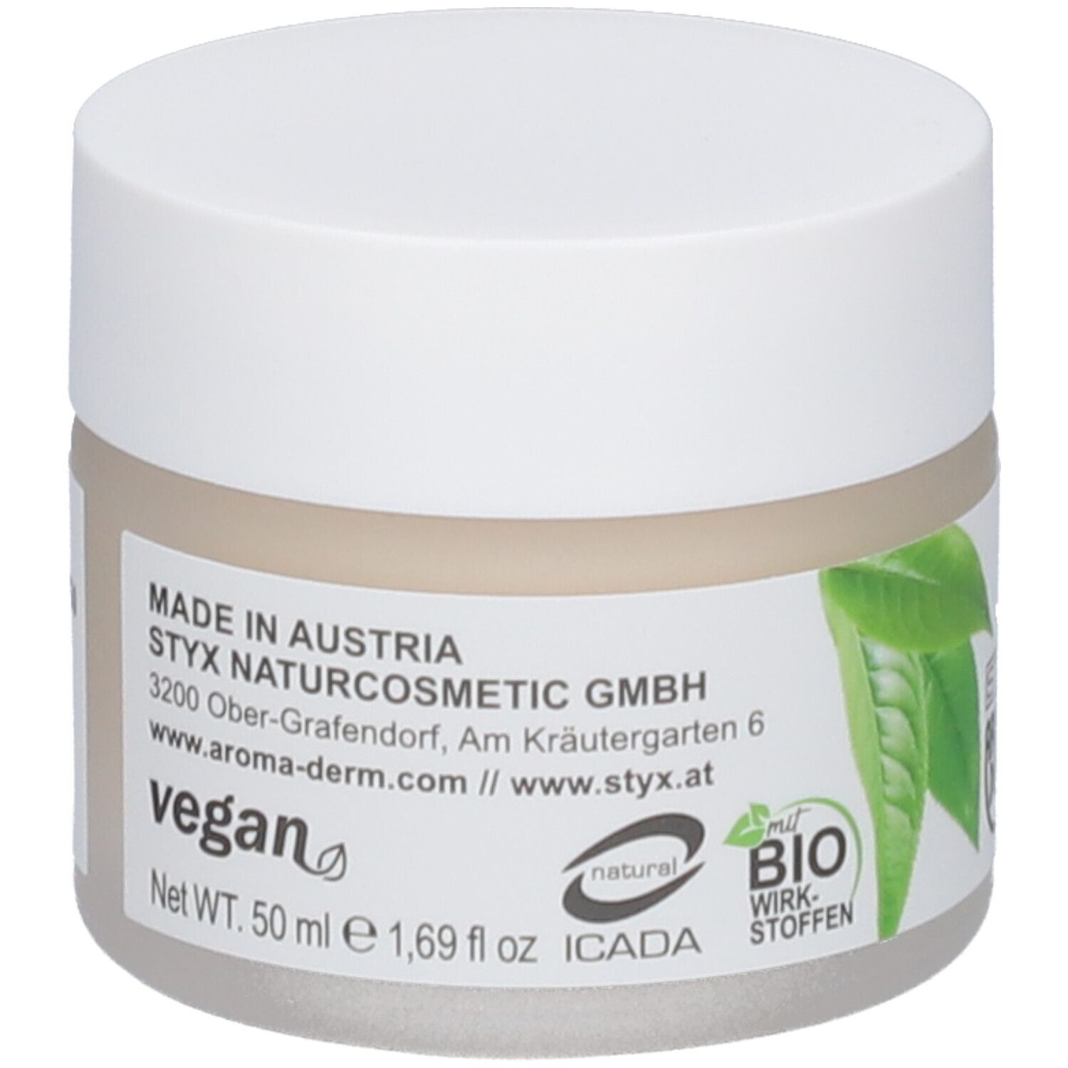 Pot de crème avec couvercle blanc. Étiquette : STYX, vegan, label bio, feuilles vertes, texte en allemand.