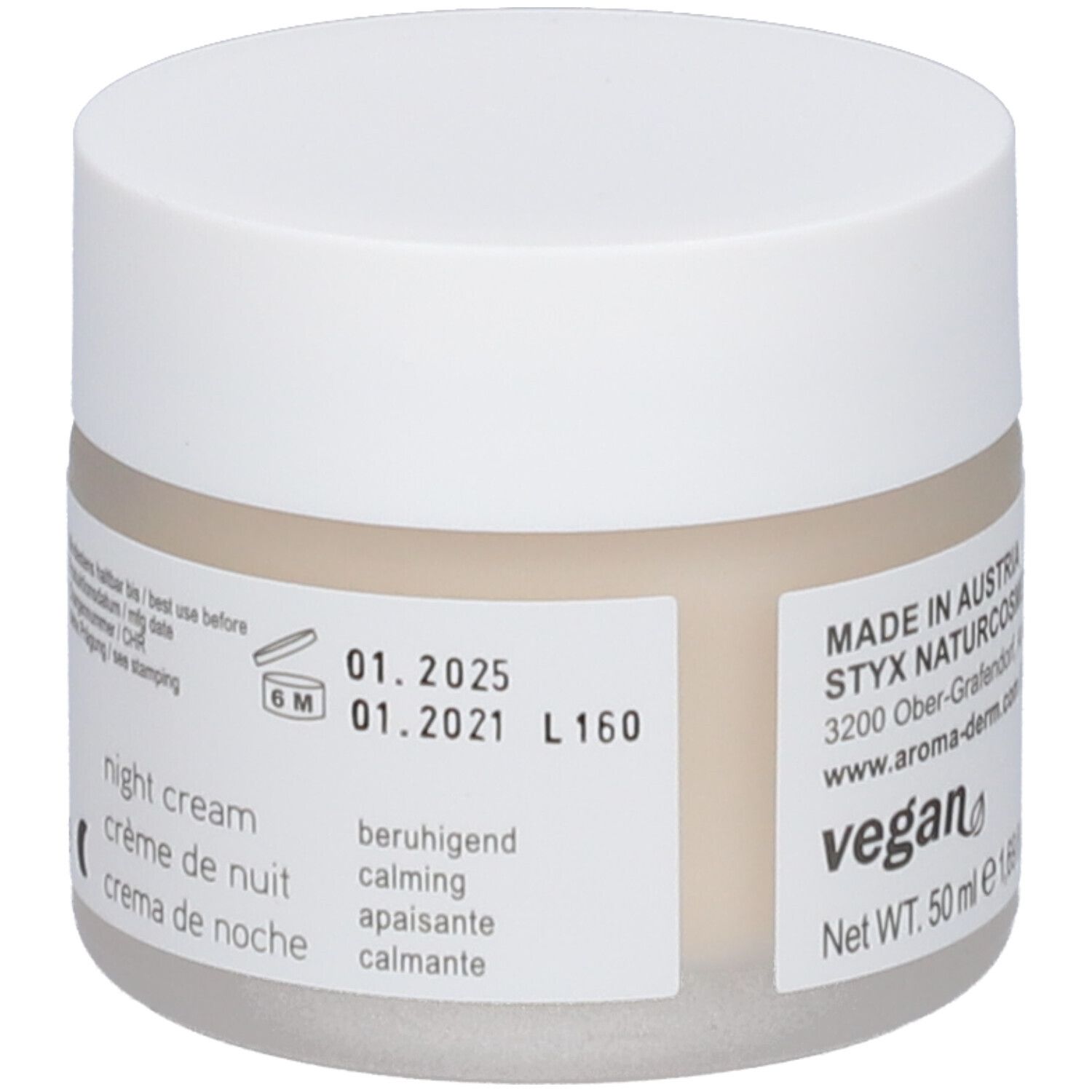 Pot de crème avec couvercle blanc. Étiquette : date de péremption, vegan, texte en allemand, italien, français, anglais.