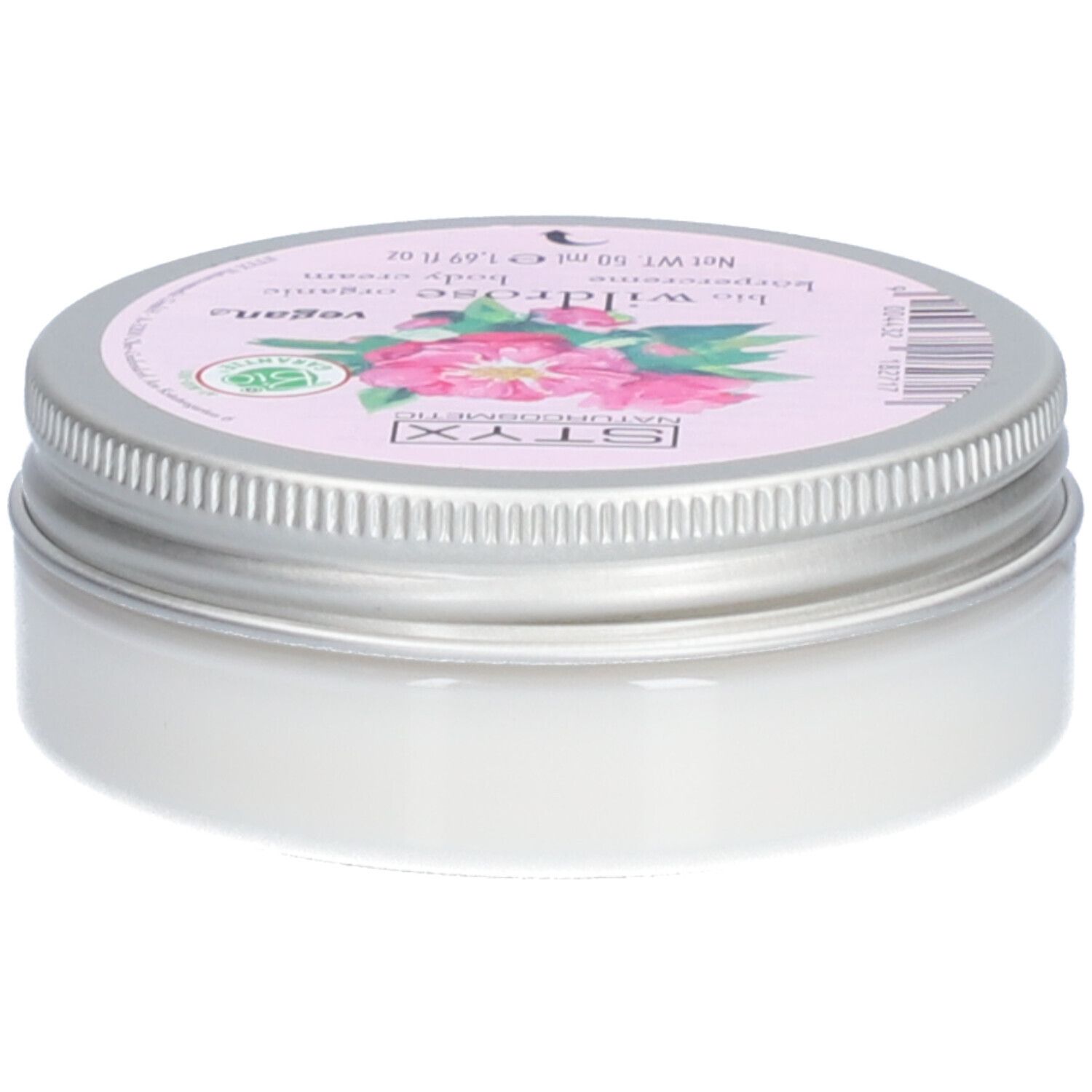 Crèmepot met deksel. Op deksel: STYX Naturkosmetik, Wildrose, vegan. Roze etiket met rozenbloemen. Pot van metaal.