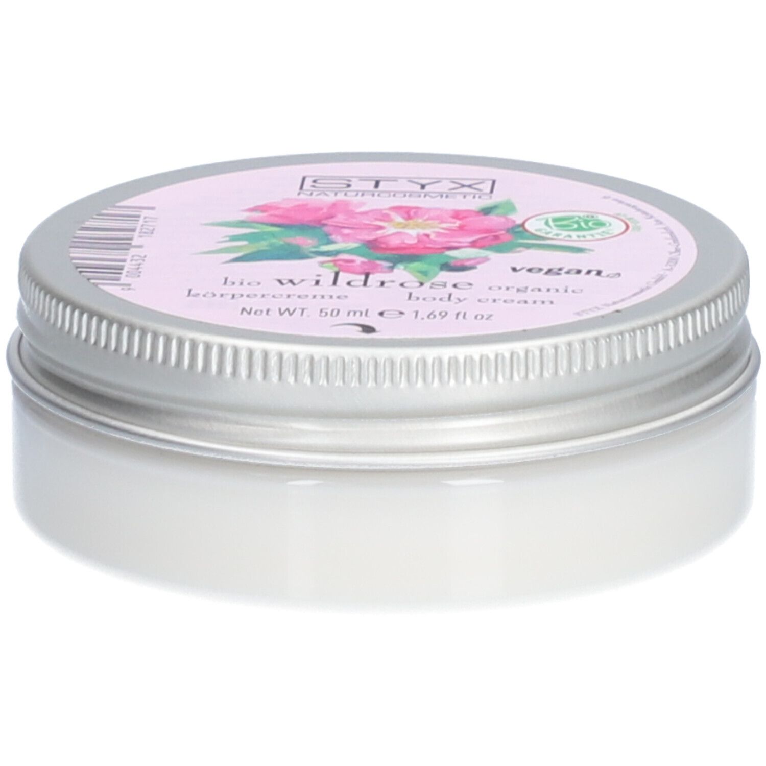 Crèmepot met deksel. Op deksel: STYX Naturkosmetik, Wildrose, vegan. Roze etiket met rozenbloemen. Pot van metaal.