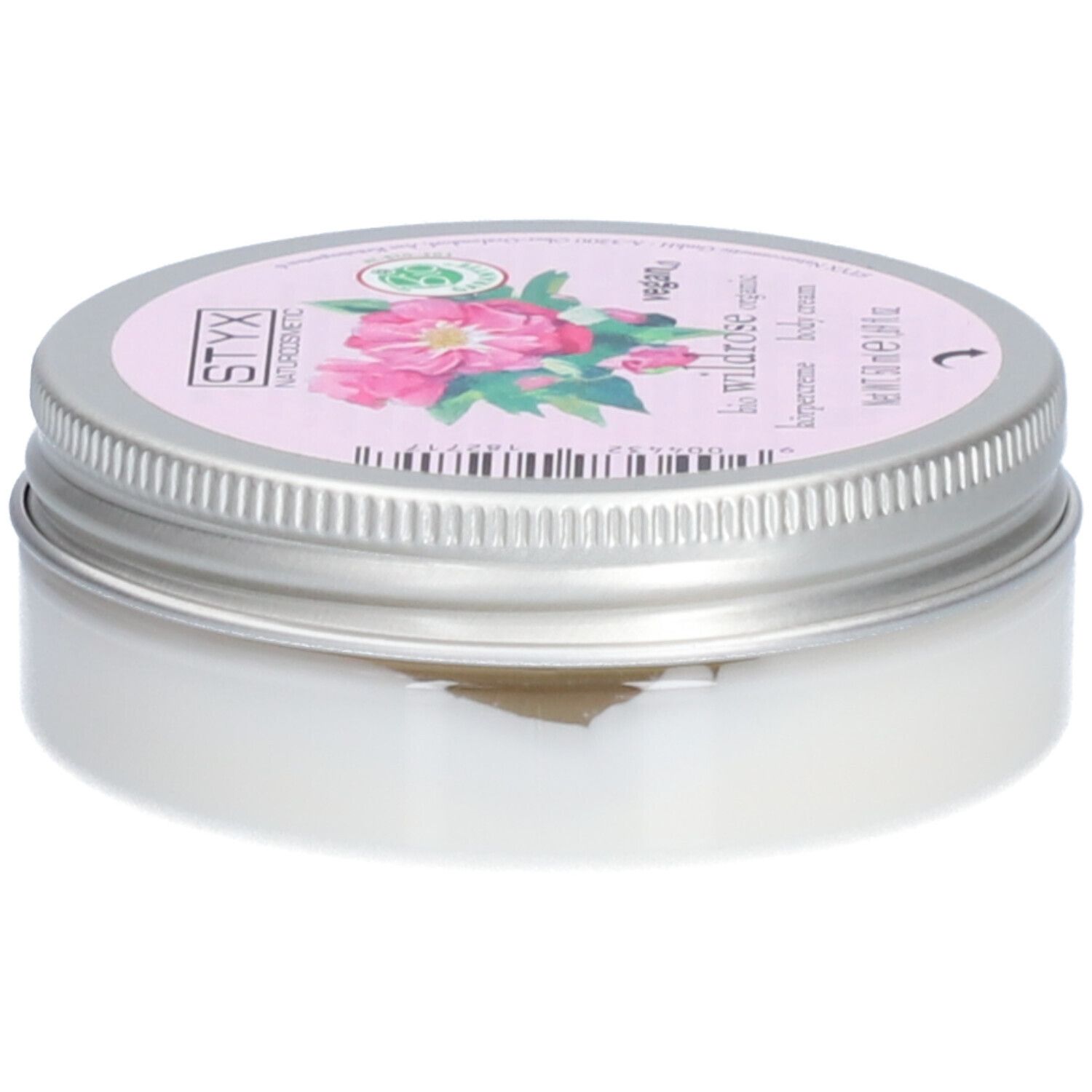 Crèmepot met deksel. Op deksel: STYX Naturkosmetik, Wildrose, vegan. Roze etiket met rozenbloemen. Pot van metaal.