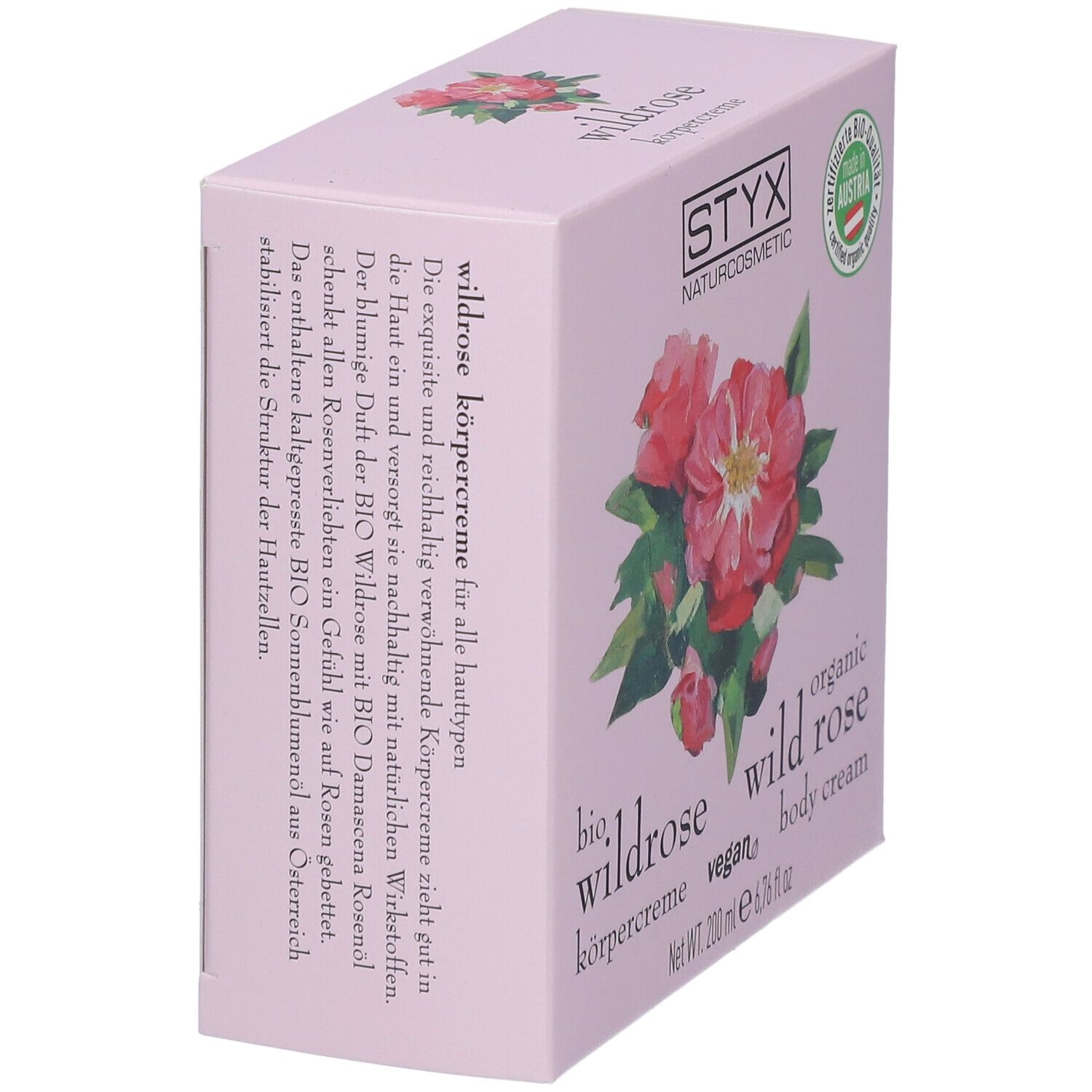 Schuinstaande roze verpakking. STYX logo, wilde roos illustratie, tekst: wilde roos bodycrème.