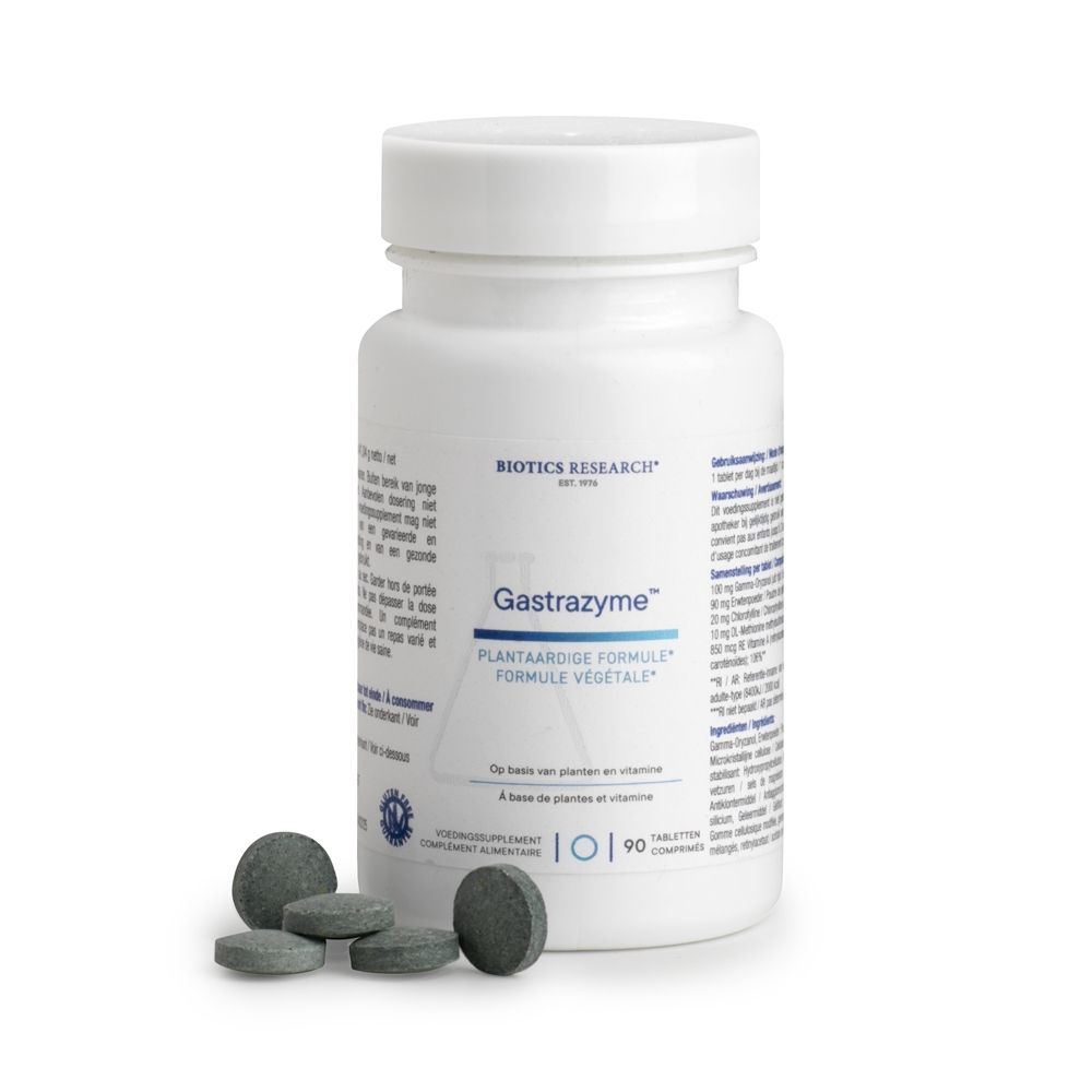 Witte fles met schroefdop en tabletten ernaast. Opschrift: Gastrazyme, Vitamine U-complex. Merk: Biotics Research.