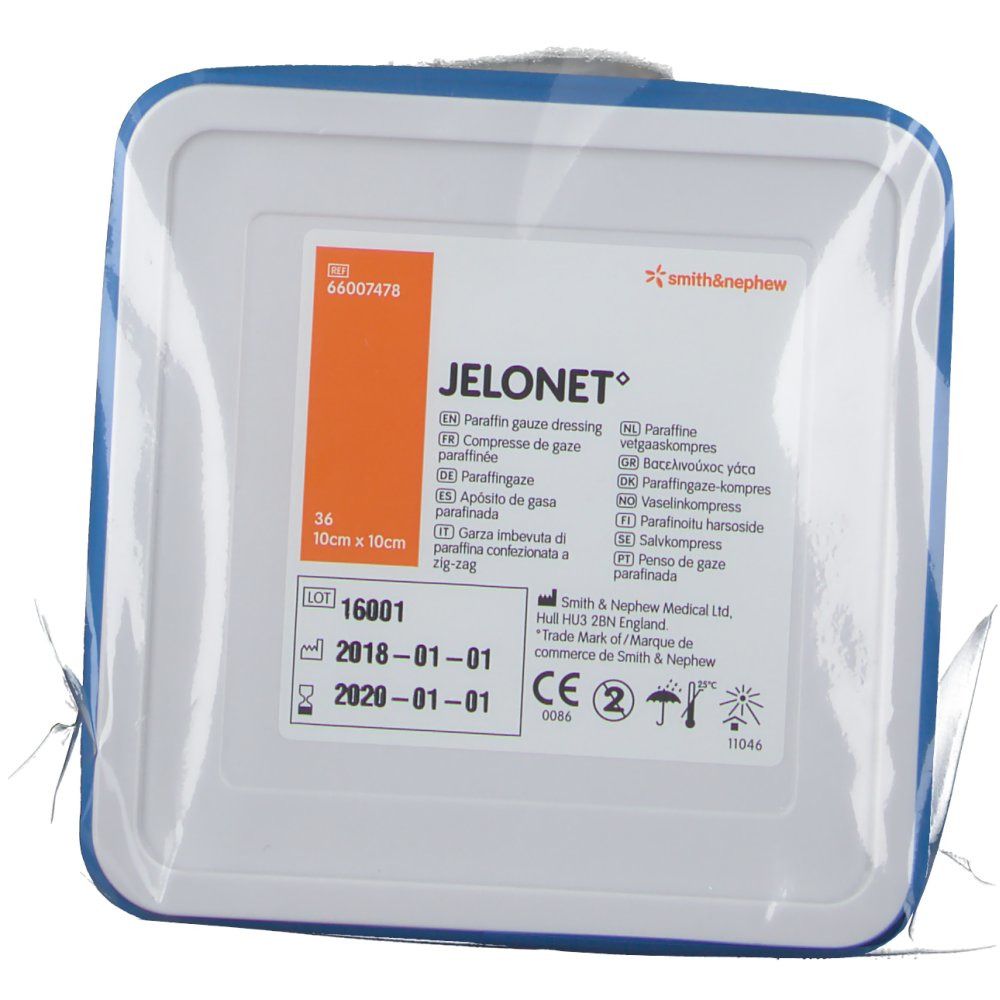 Verpakking met JELONET zalfkompres. Vierkant, blauwe rand. Tekst: 10 cm x 10 cm, Smith & Nephew logo.