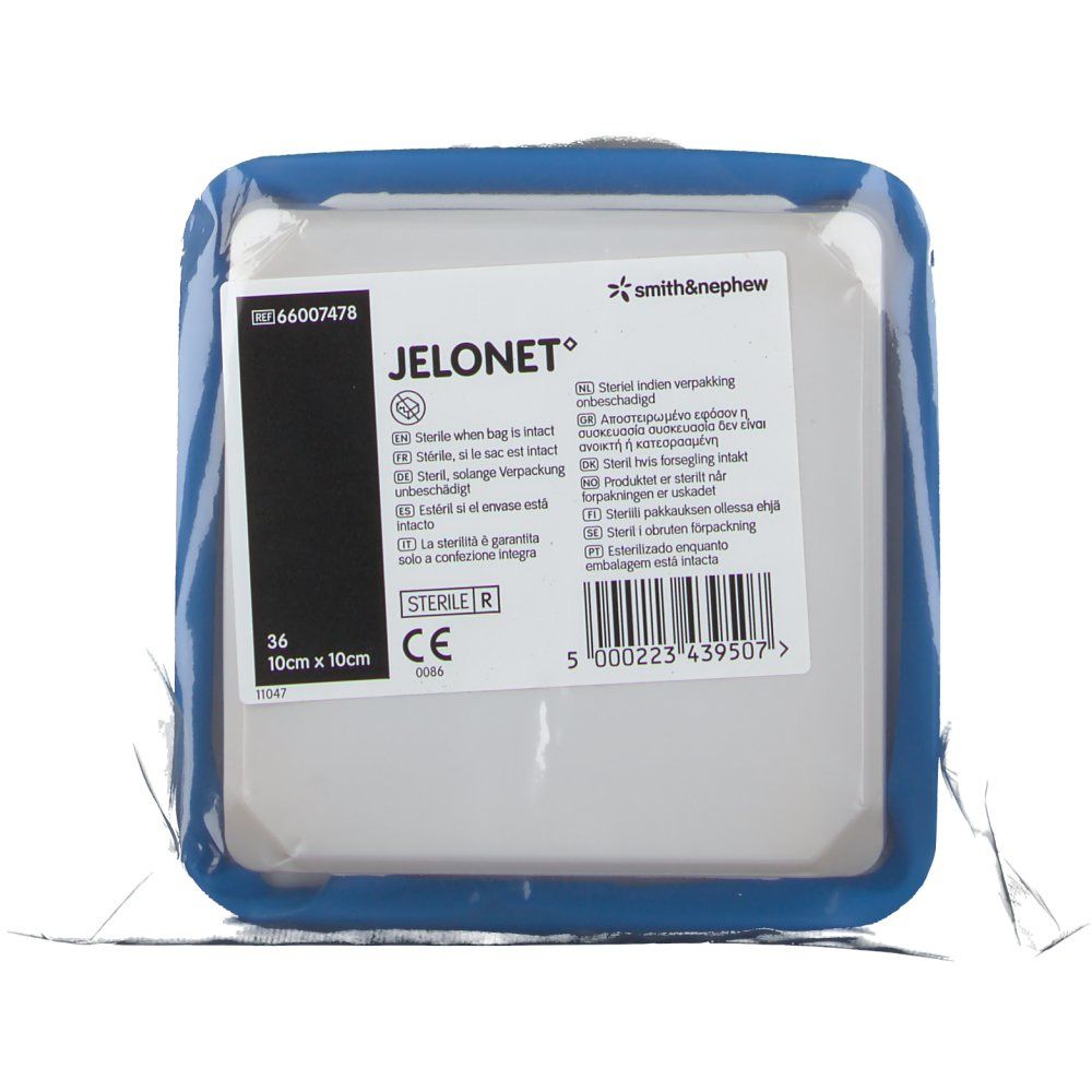 Verpakte JELONET zalfkompres. Vierkant, blauwe rand. Tekst: 10 cm x 10 cm, Smith & Nephew logo.