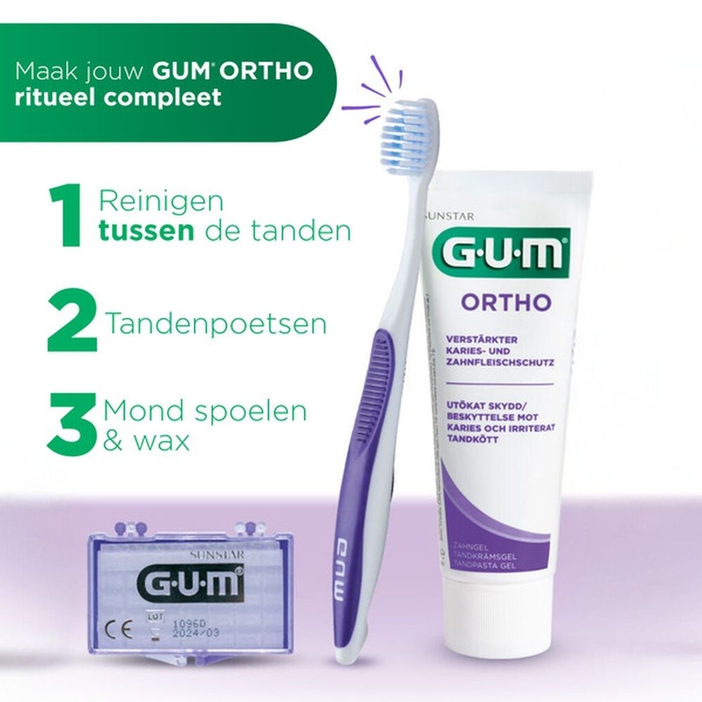 Tandenborstel met paarse handgreep en witte borstelkop. GUM logo.