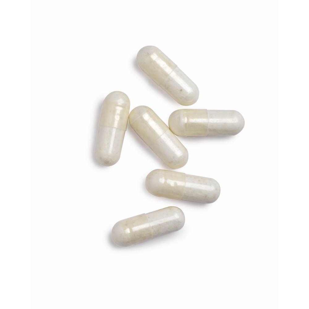 Verschillende witte capsules. Geen opschrift zichtbaar.