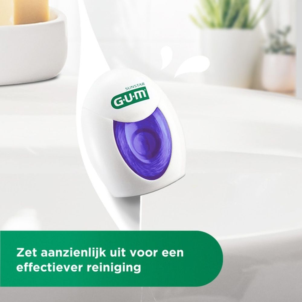 GUM® Expanding Floss in verpakking. Witte dispenser met paarse inzet. Groene verpakking met productnaam en logo.