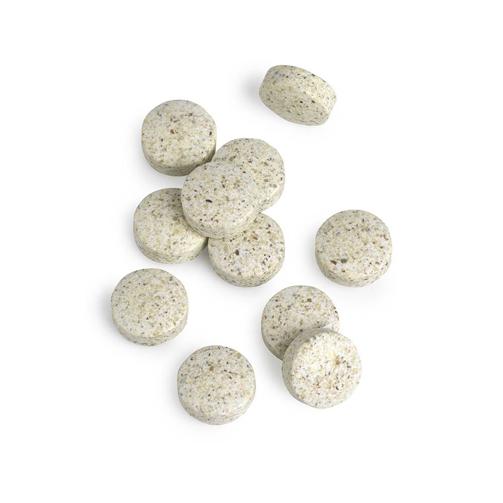 Close-up van tabletten. Ronde, beige tabletten met kleine puntjes.