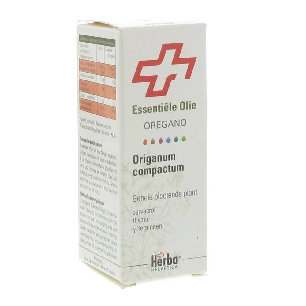 Kartonnen verpakking met rood kruislogo. Tekst: Essentiele Olie Oregano Origanum compactum. Herba Helvetica logo.