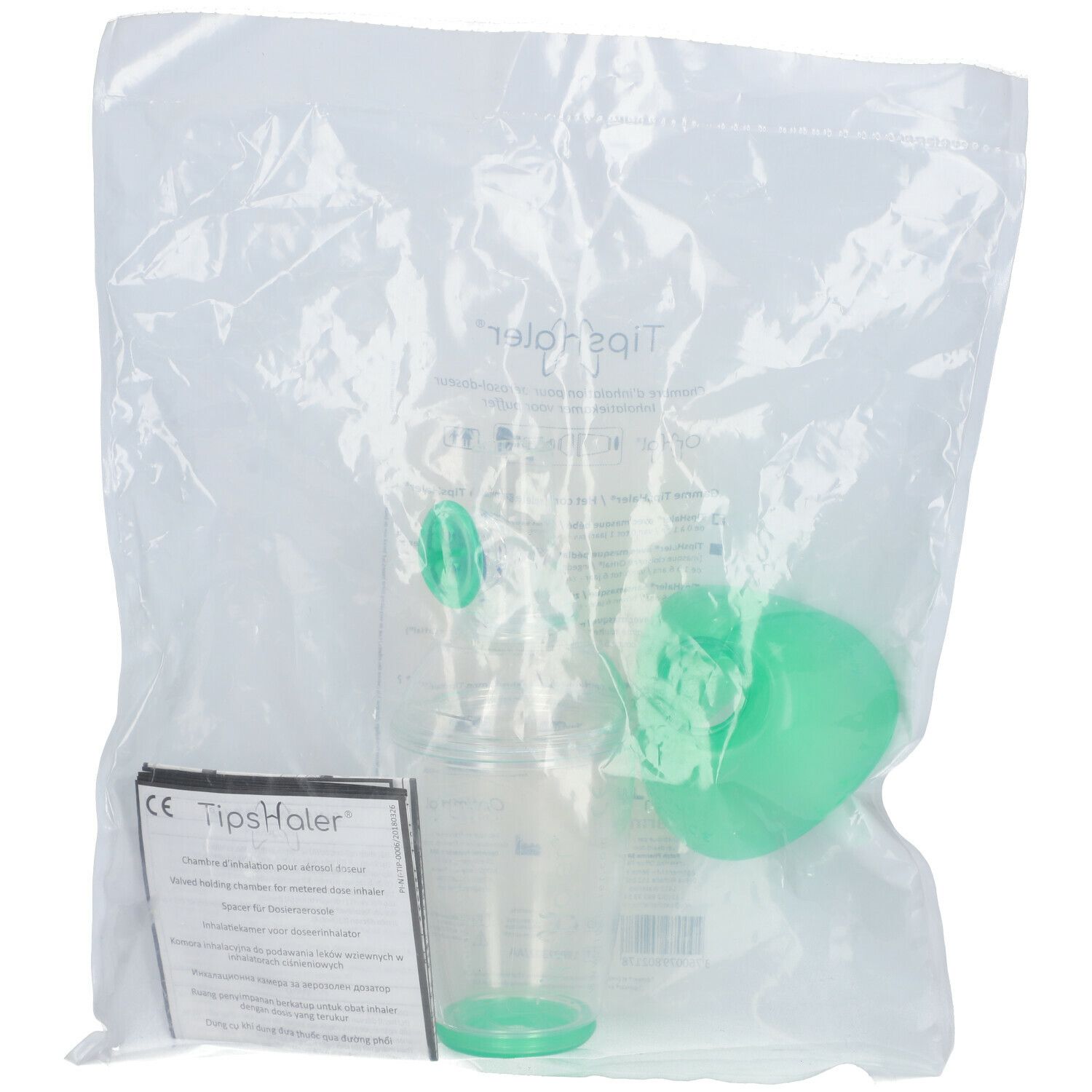 Emballage avec chambre d'inhalation, masque et accessoires. Masque vert, chambre transparente.