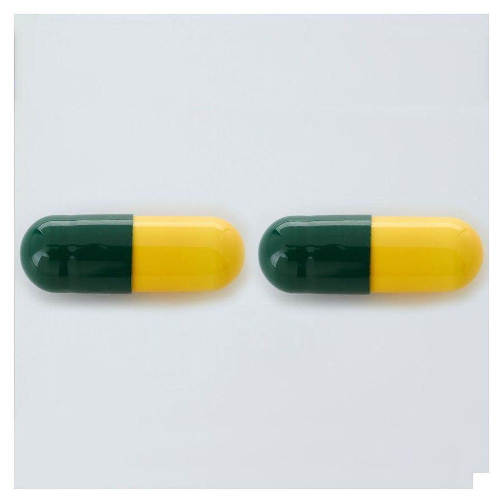 Deux gélules jaune-vert. Sur fond blanc.