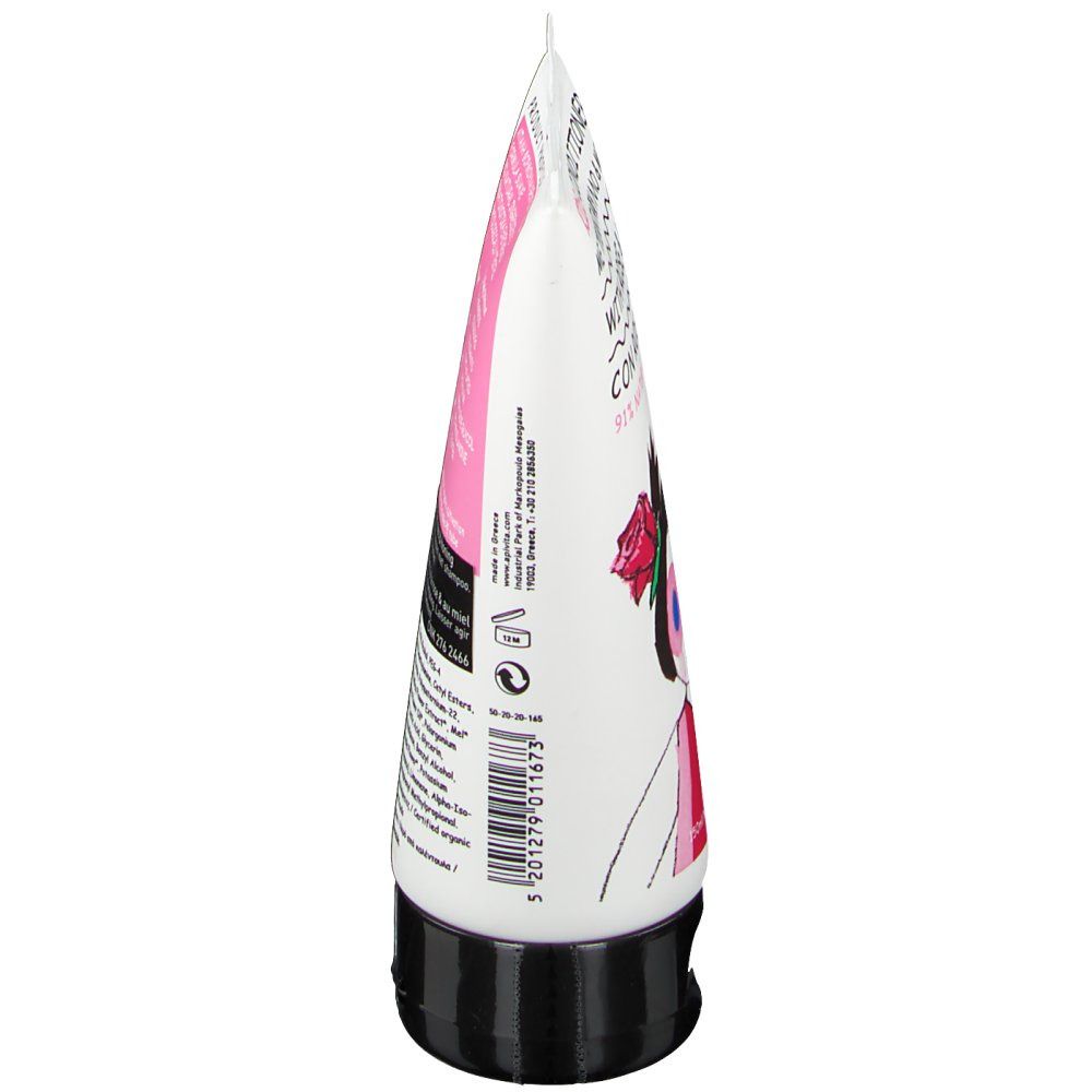 Vue latérale d'un tube blanc avec bouchon noir. Détails roses et noirs. Texte sur le tube.