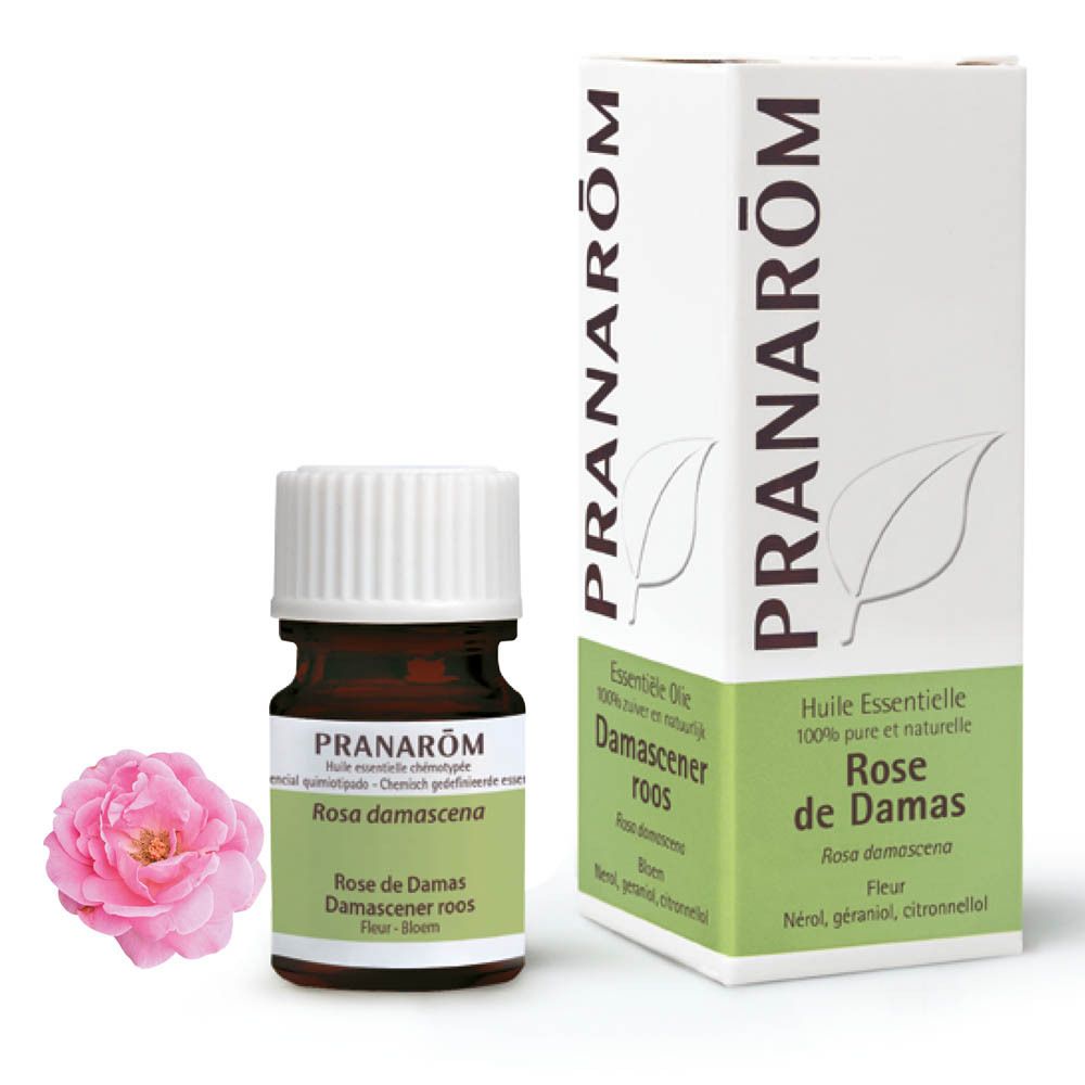 Productfles, verpakking en roos. Bruine fles met witte dop. Verpakking met merk PRANAROM.