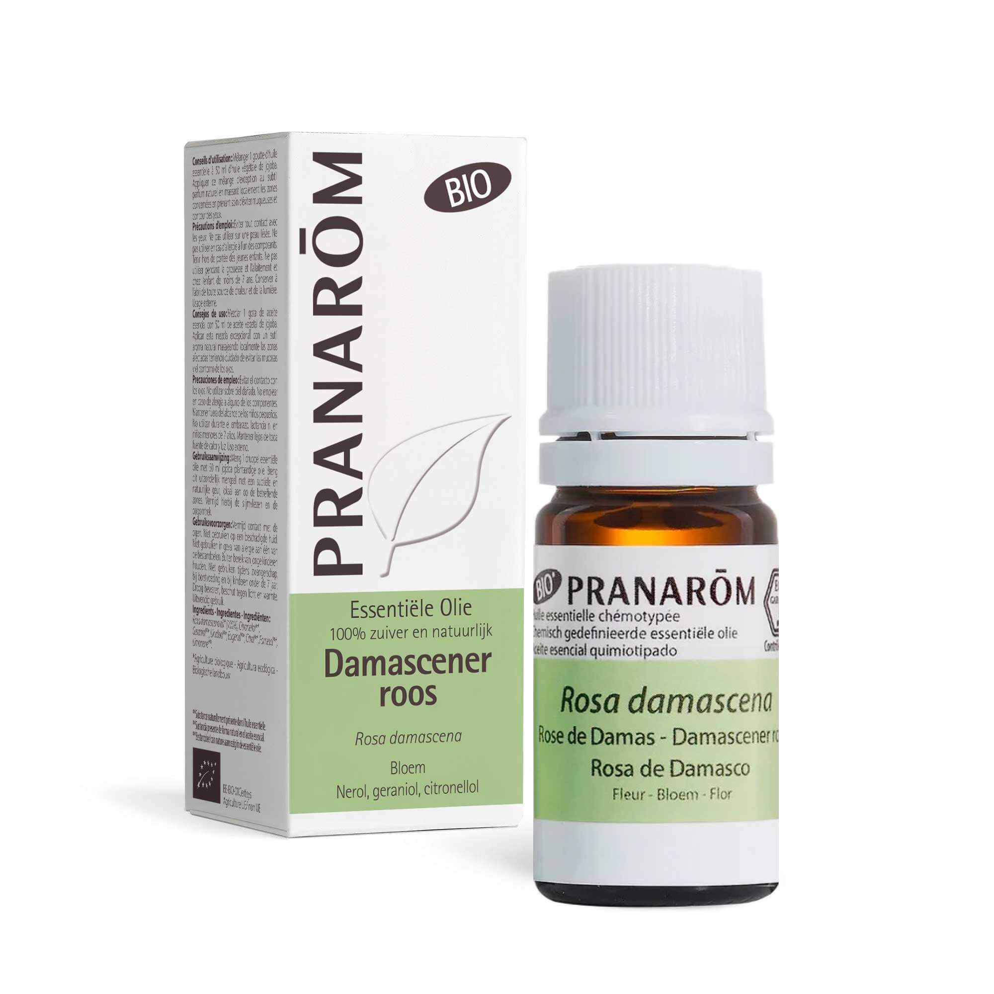Bruine glazen fles met witte dop en doos. Opschrift: PRANAROM, Rosa damascena, BIO.