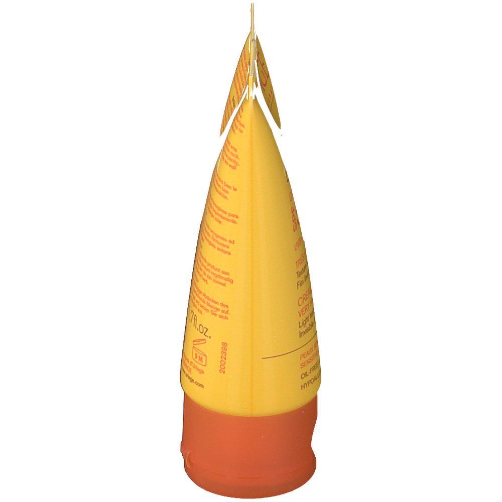Tube jaune, bouchon orange. Informations produit sur le tube.