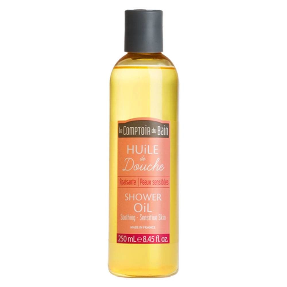 Fles douche-olie met gele vloeistof. Etiket met "Le Comptoir du Bain", "Huile Douche", "Shower Oil". Inhoud 250 ml.