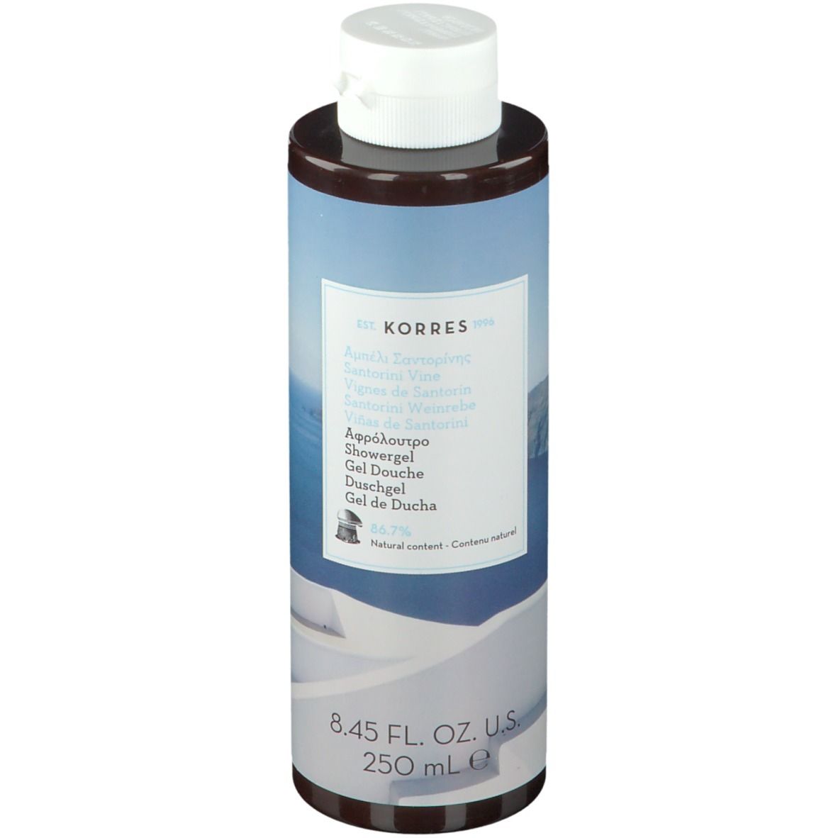 Gel douche KORRES Santorini. Flacon cylindrique avec bouchon blanc. Étiquette avec nom et informations.