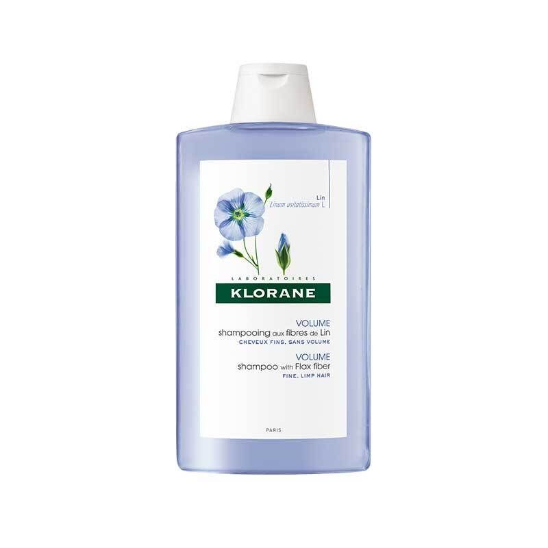 Shampoo Klorane aux fibres de lin. Flacon bleu avec bouchon blanc. Étiquette avec motif floral et nom du produit.