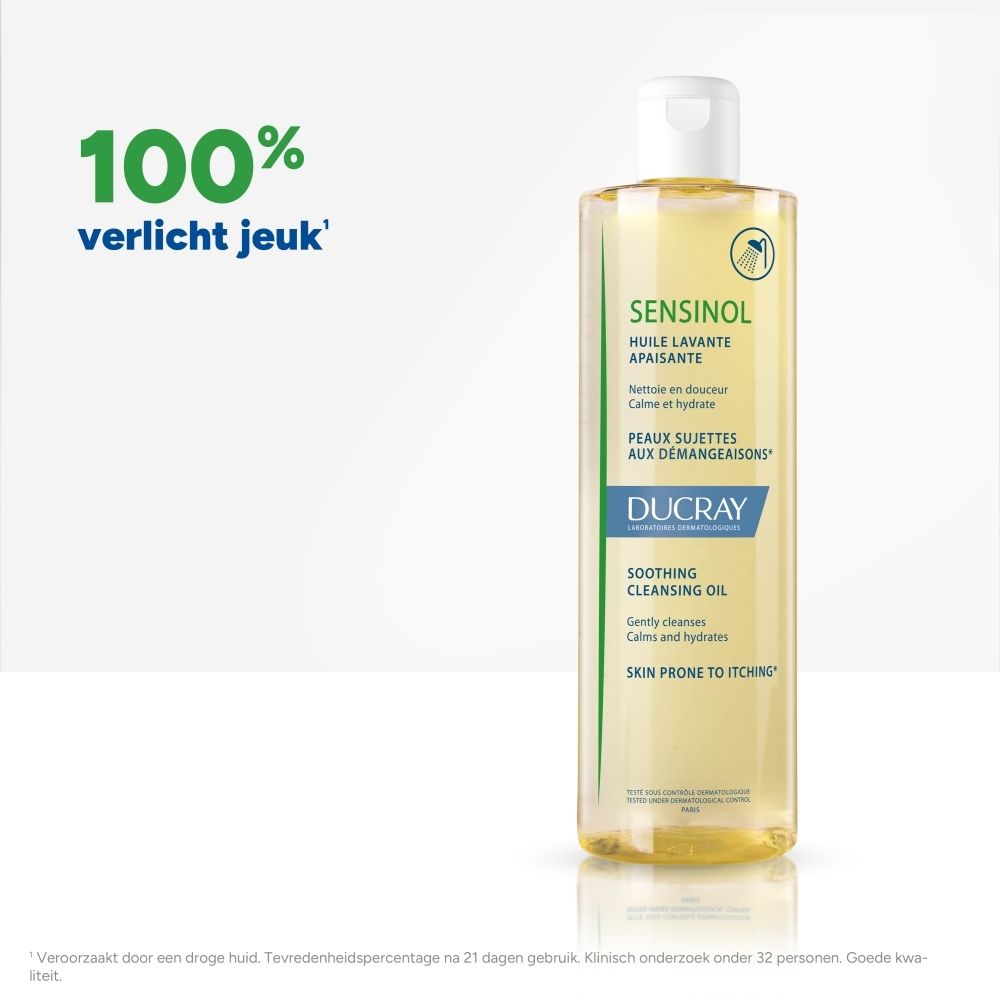 Fles DUCRAY SENSINOL douche-olie. Geelachtige vloeistof. Witte dop. Groene en blauwe belettering.
