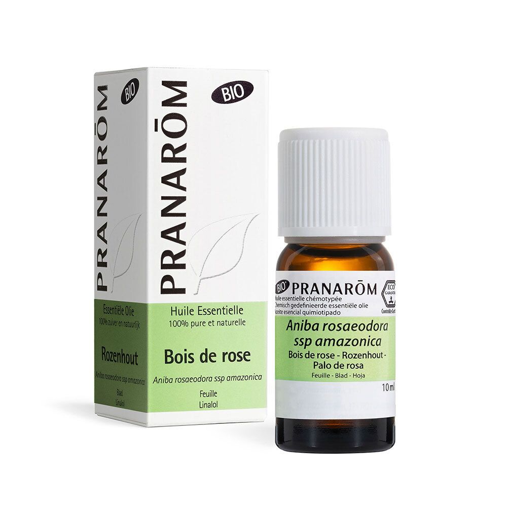 Flacon en verre brun avec bouchon blanc. Étiquette avec informations produit. Boîte en arrière-plan.