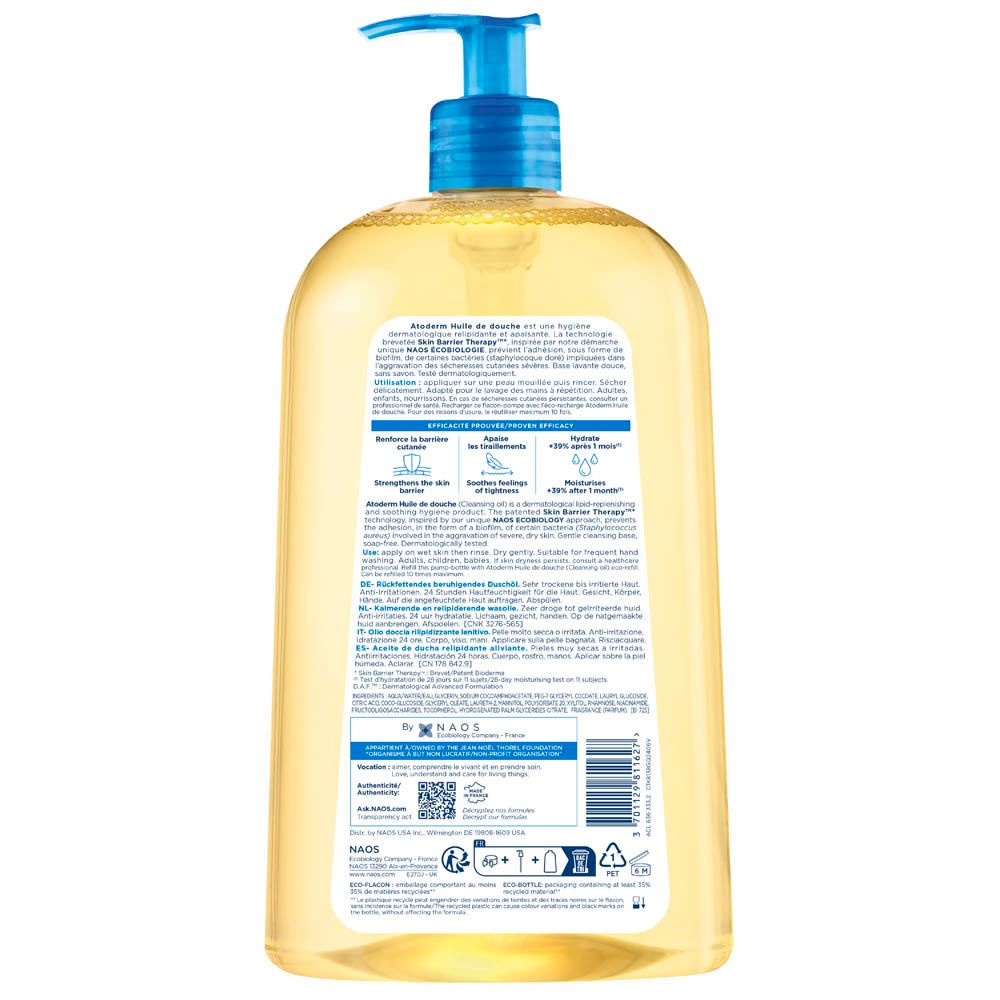 Achterkant van de BIODERMA Atoderm Huile de douche fles. Tekst en barcode. Blauw-witte tekst op transparante achtergrond.