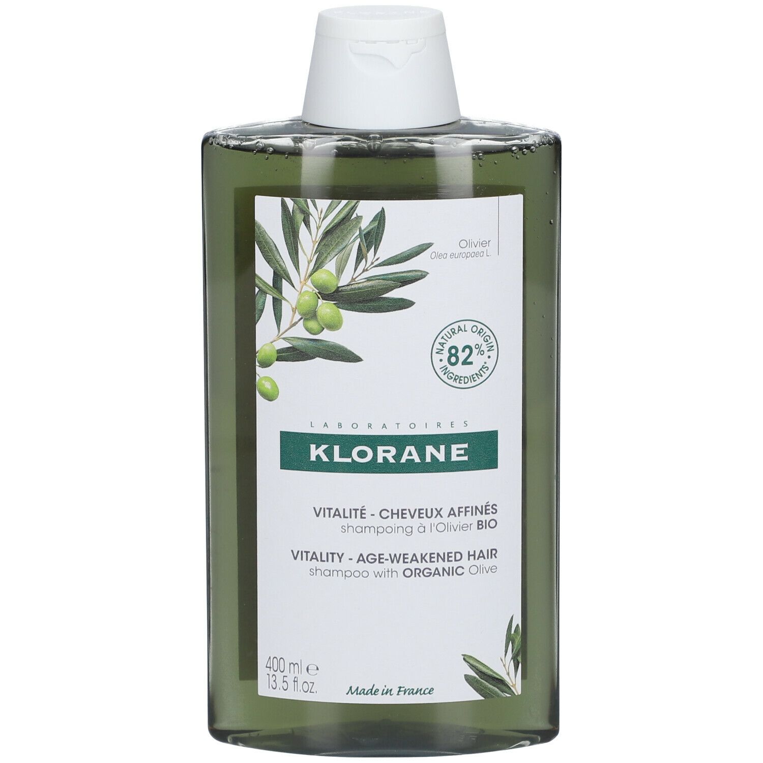 Flacon de shampooing vert avec bouchon blanc. Étiquette avec illustration d'olives et texte: KLORANE, Vitalité, 82% ingrédients d'origine naturelle.