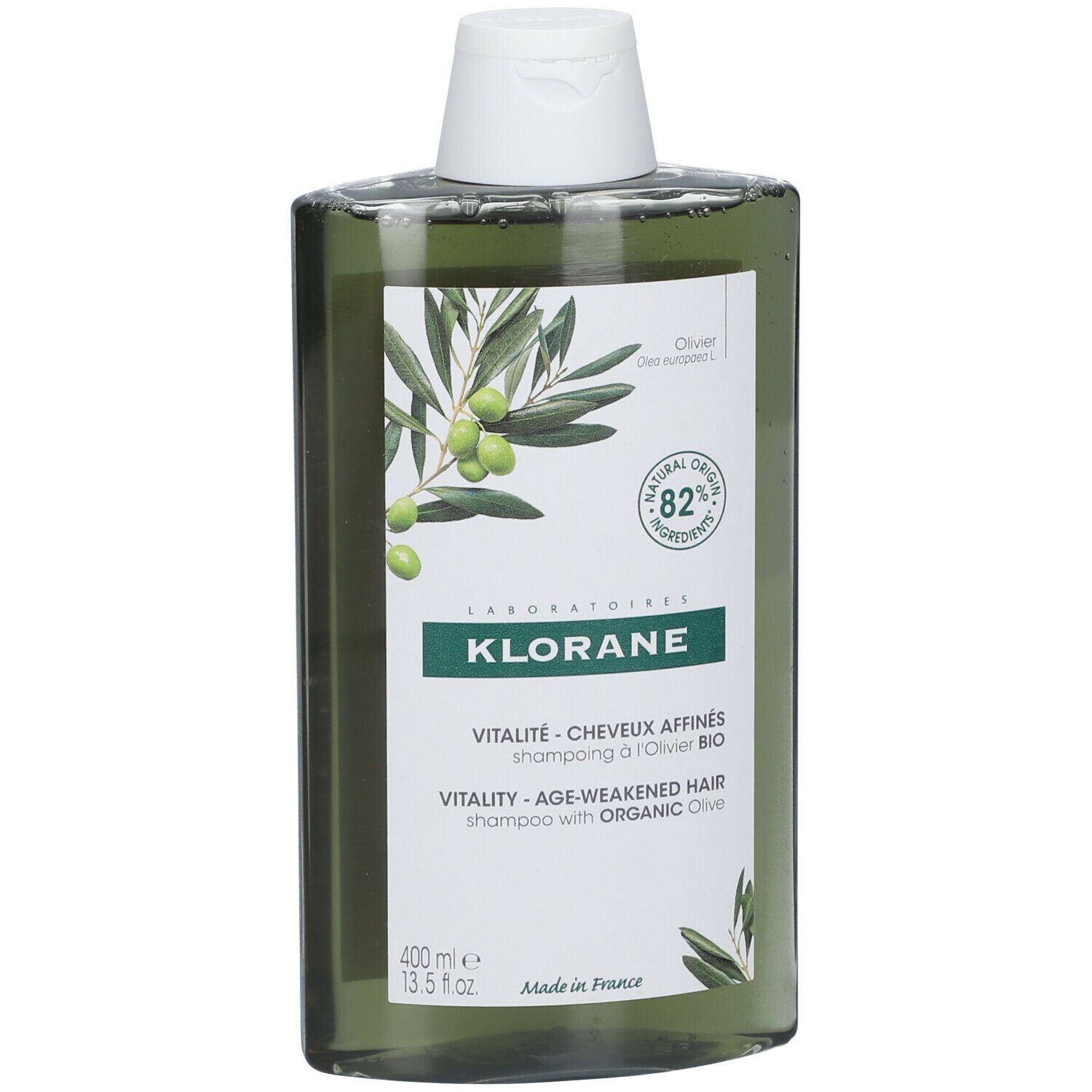 Flacon de shampooing vert avec bouchon blanc. Étiquette avec illustration d'olives et texte: KLORANE, Vitalité, 82% ingrédients d'origine naturelle.