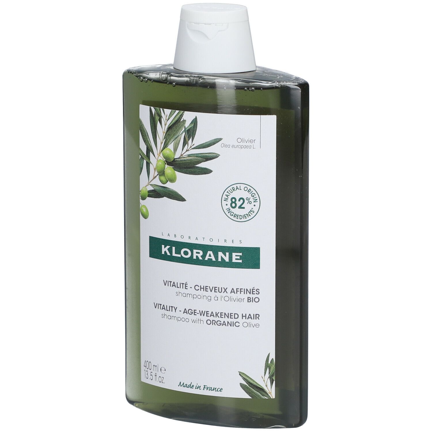 Flacon de shampooing vert avec bouchon blanc. Étiquette avec illustration d'olives et texte: KLORANE, Vitalité, 82% ingrédients d'origine naturelle.