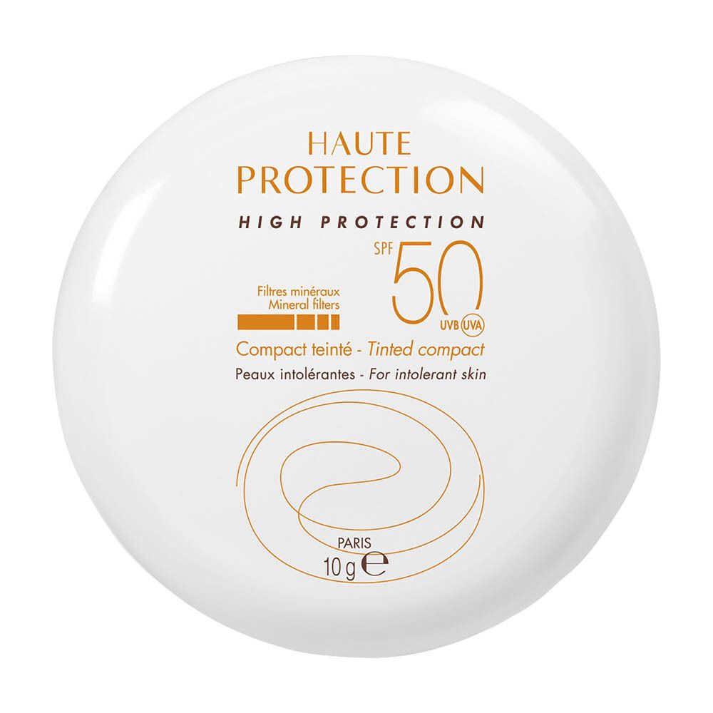 Poudre compacte blanche avec écriture orange. Texte : HAUTE PROTECTION, SPF 50, Compact teinté.