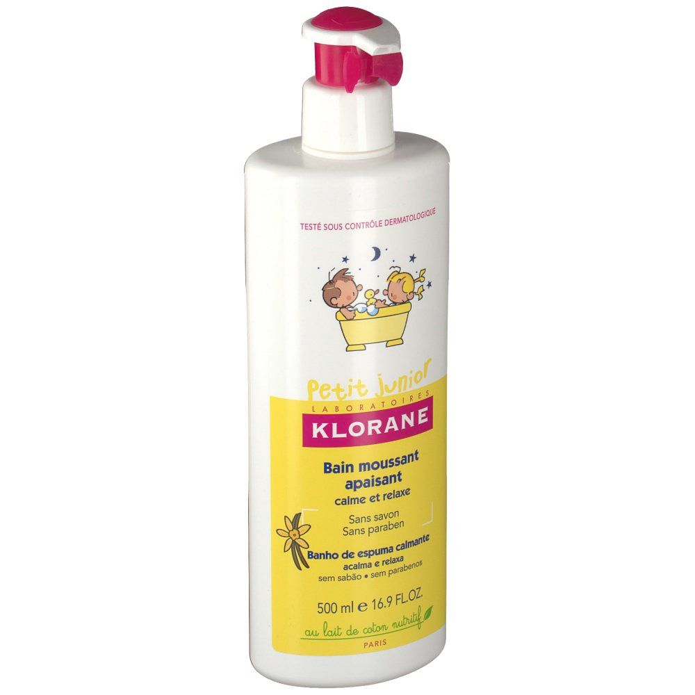 Witte fles met roze pomp. Geel etiket met tekst en illustraties. Opschrift: Klorane Petit Junior, kalmerende badschuim.