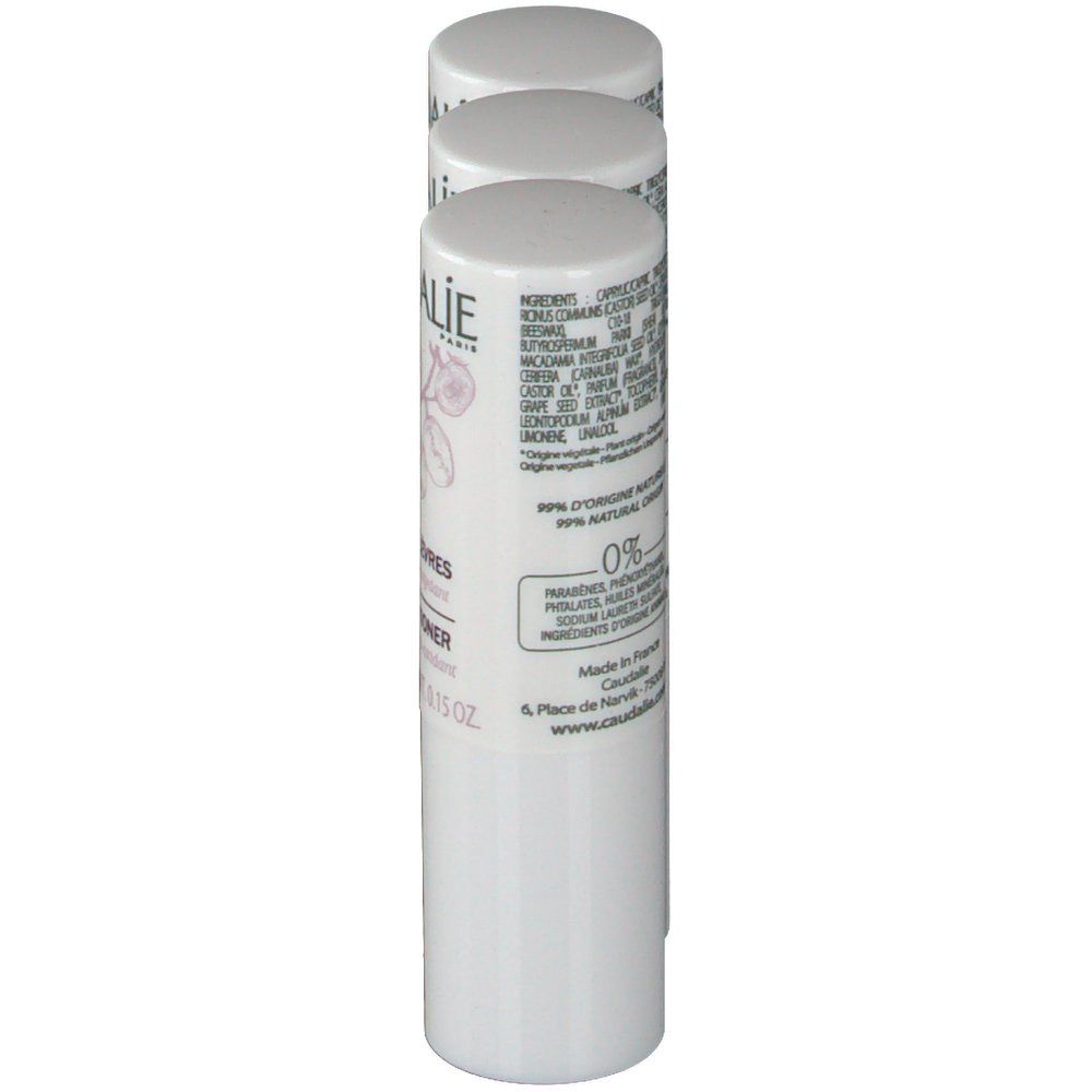 Trois sticks blancs. Inscription: Caudalie, Soin des Lèvres, Lip Conditioner. Ingrédients visibles et indication 0%.