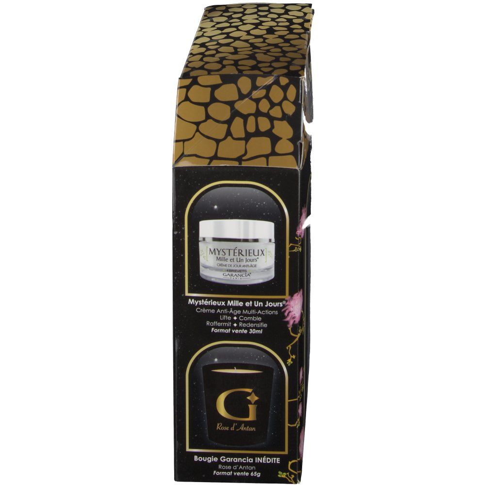 Vue latérale du coffret cadeau. Contient crème et bougie. Emballage noir avec motif doré et noms de produits.