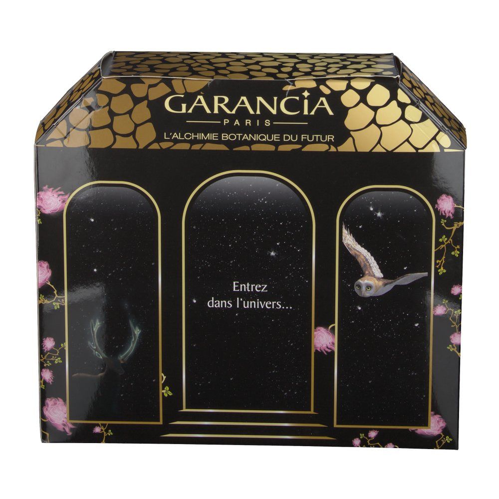 Coffret cadeau avec design fenêtres. Emballage noir avec accents dorés. Texte : "Entrez dans l'univers..."