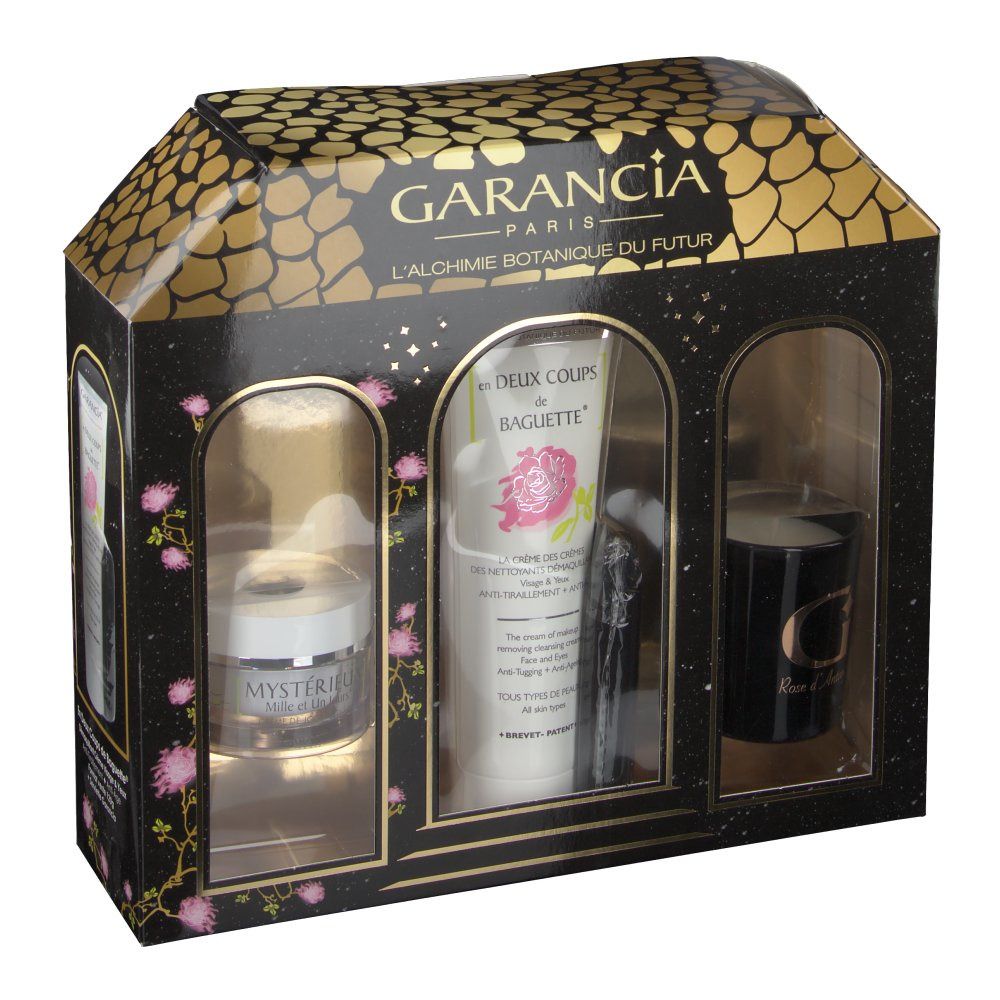 Coffret cadeau avec trois produits : crème, tube et bougie. Emballage noir et or avec design fenêtres.