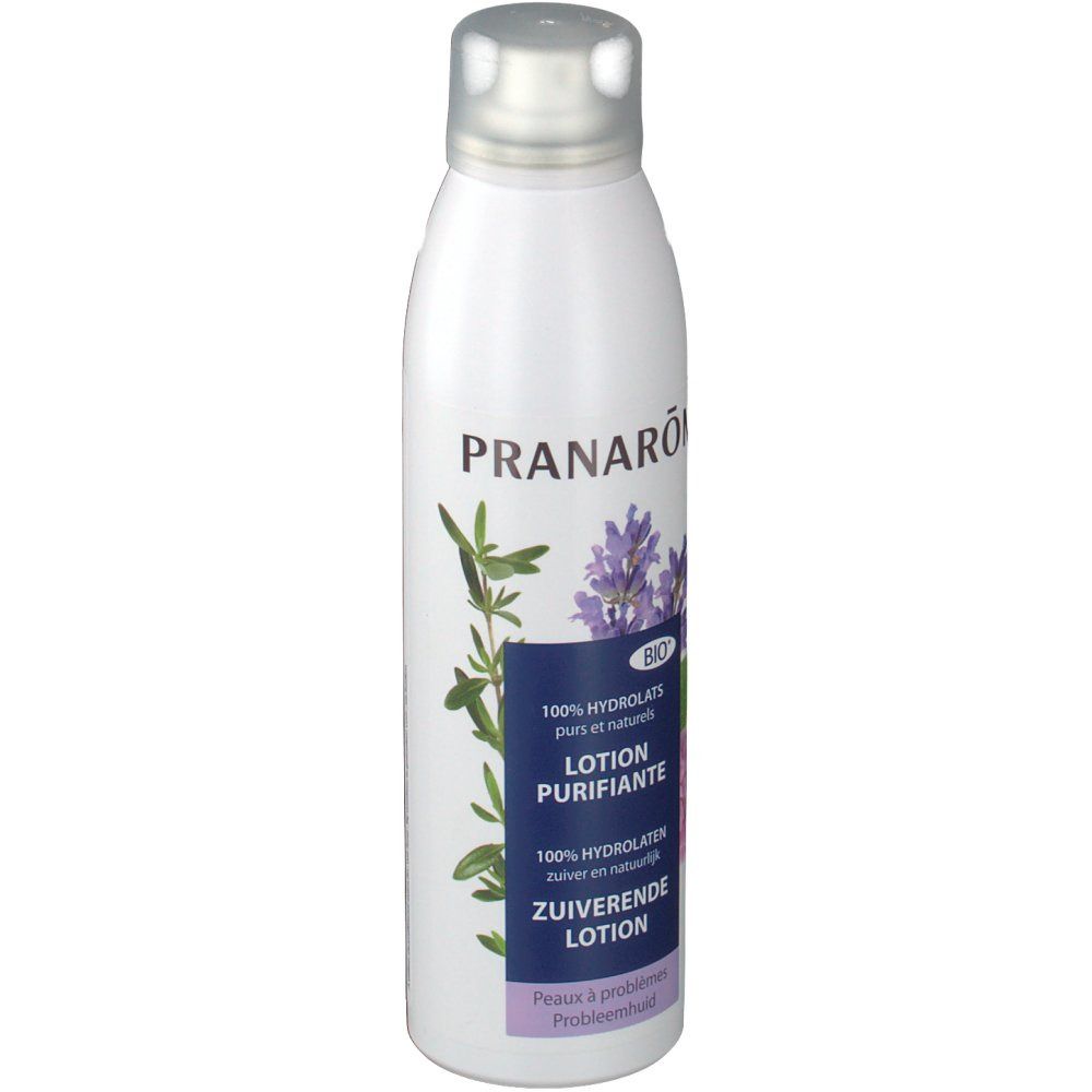 Witte fles met zilveren dop. Opschrift: PRANAROM, Lotion Purifiante, Bio-label. Afbeelding van bloemen en bladeren.