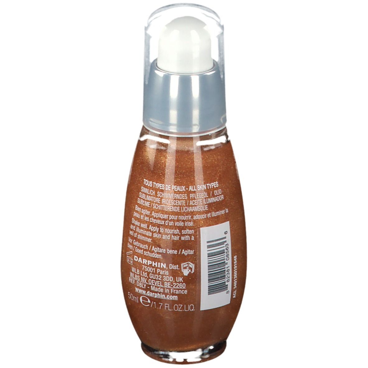 Achteraanzicht van de oliefles. Transparante dop, zilveren kraag, bruine olie. Tekst: Tous types de peaux, 50ml, Schudden voor gebruik.