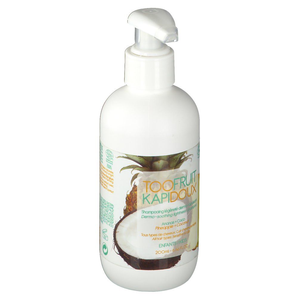 Witte fles met pomp. Etiket met tekst, ananas- en kokosnoot illustraties. Productnaam zichtbaar.