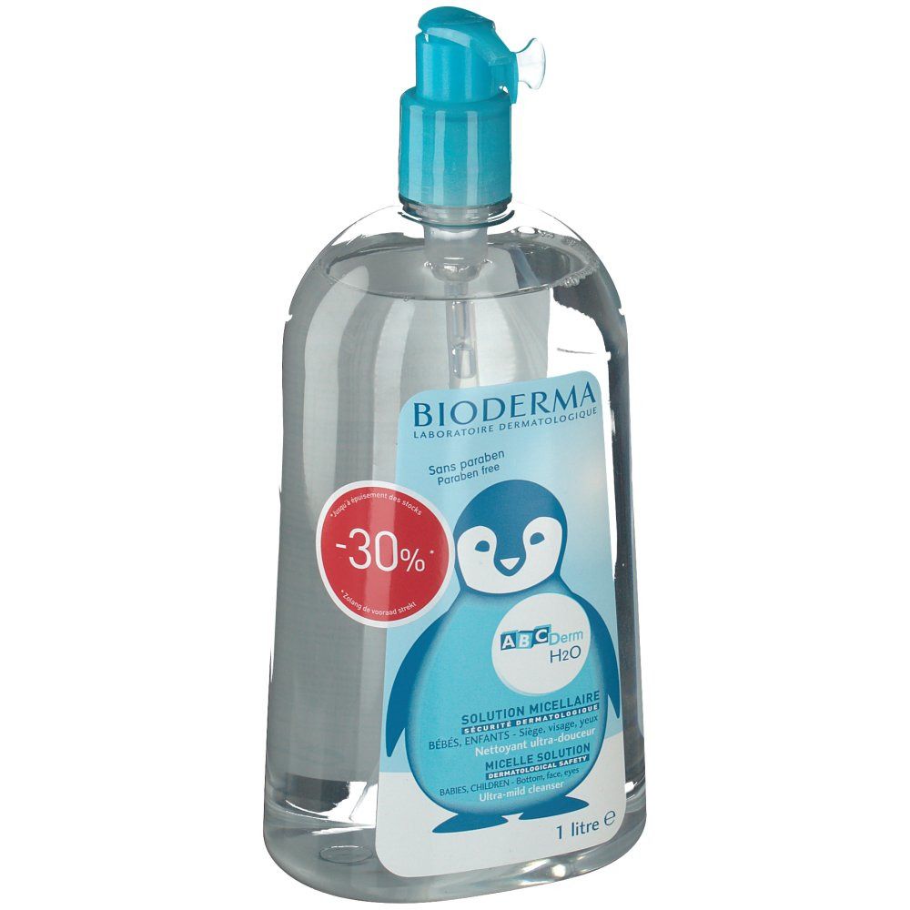 Heldere vloeistof in fles met blauwe pompdeksel. Etiket met pinguïnillustratie, productnaam en -30% korting.