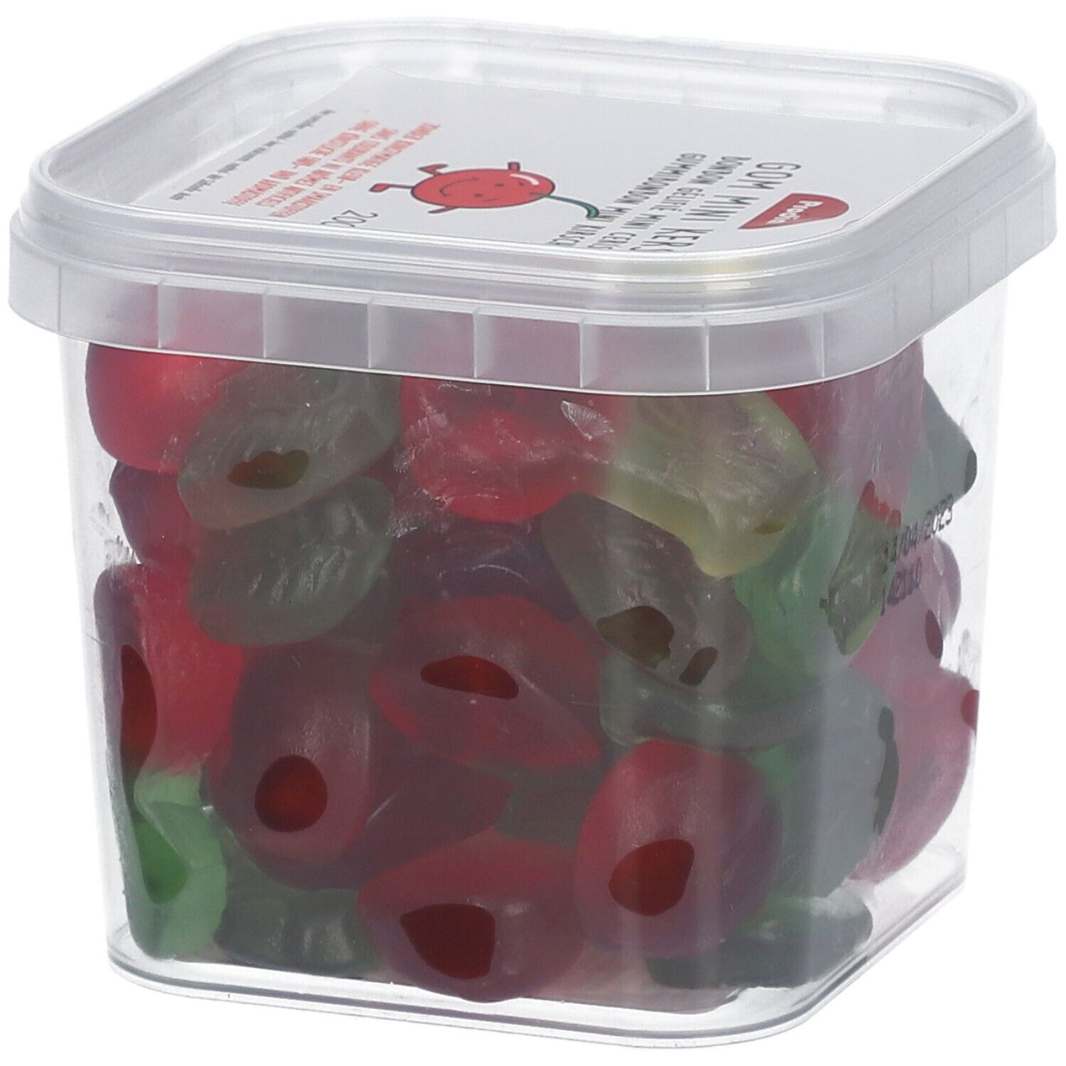 Boîte transparente avec bonbons gélifiés aux cerises. Couvercle avec nom du produit et illustration de cerise. Bonbons rouges et verts.