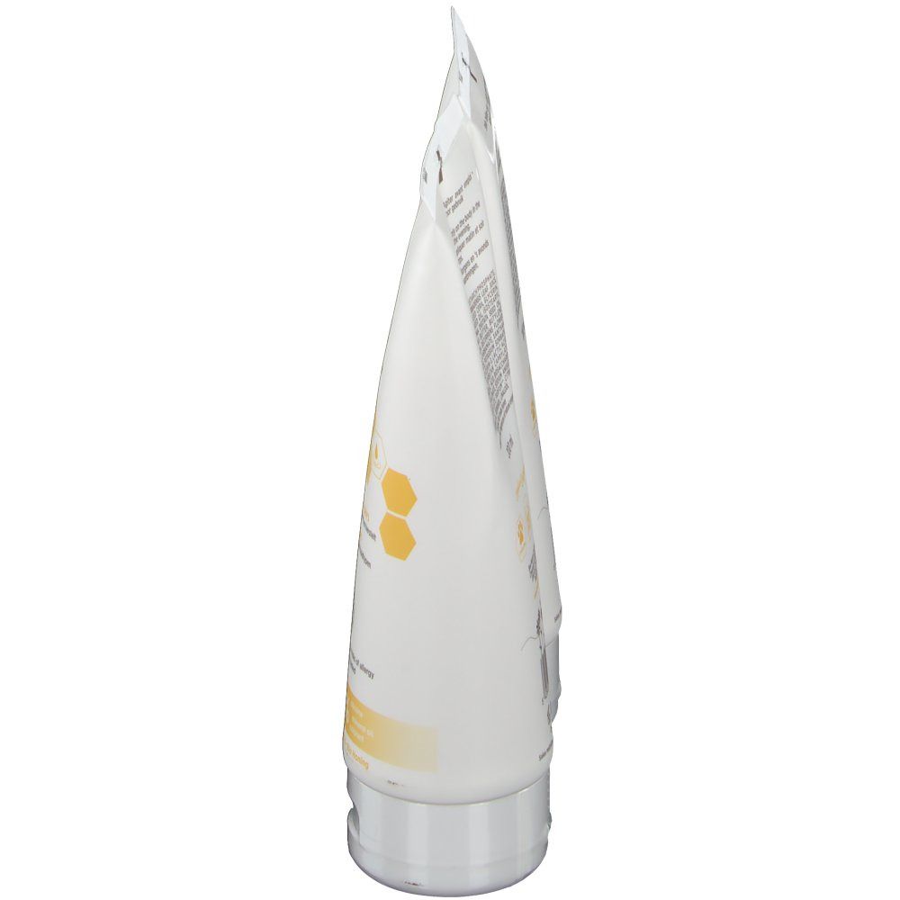 Zijaanzicht van een tube Body Milk. Witte tube met productinformatie. Grijze dop.