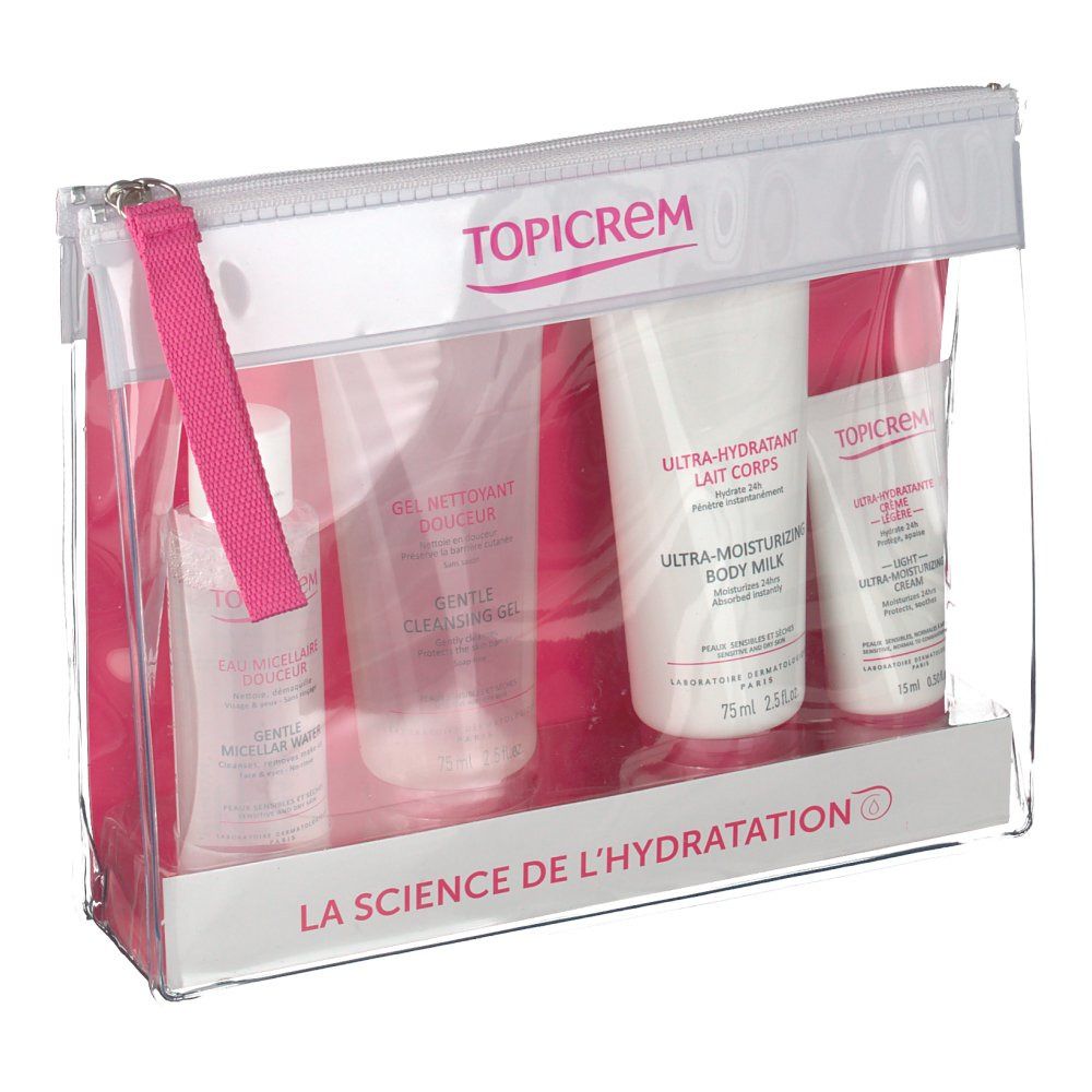 Trousse de voyage transparente Topicrem avec quatre produits. Contient gel nettoyant, lait corporel, crème et eau micellaire. Détails roses.