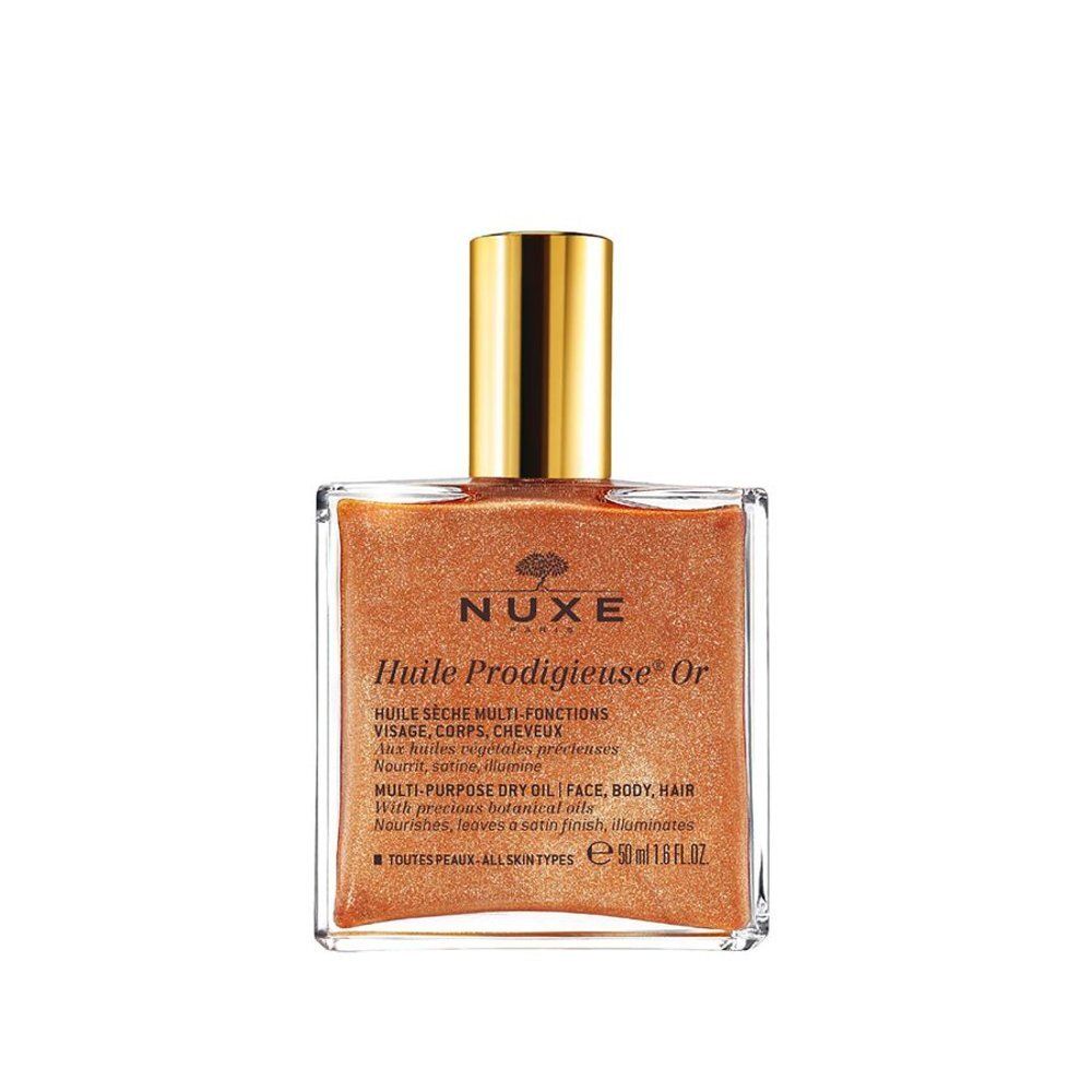 NUXE Huile Prodigieuse Or: Glazen fles met gouden dop en open verpakking.