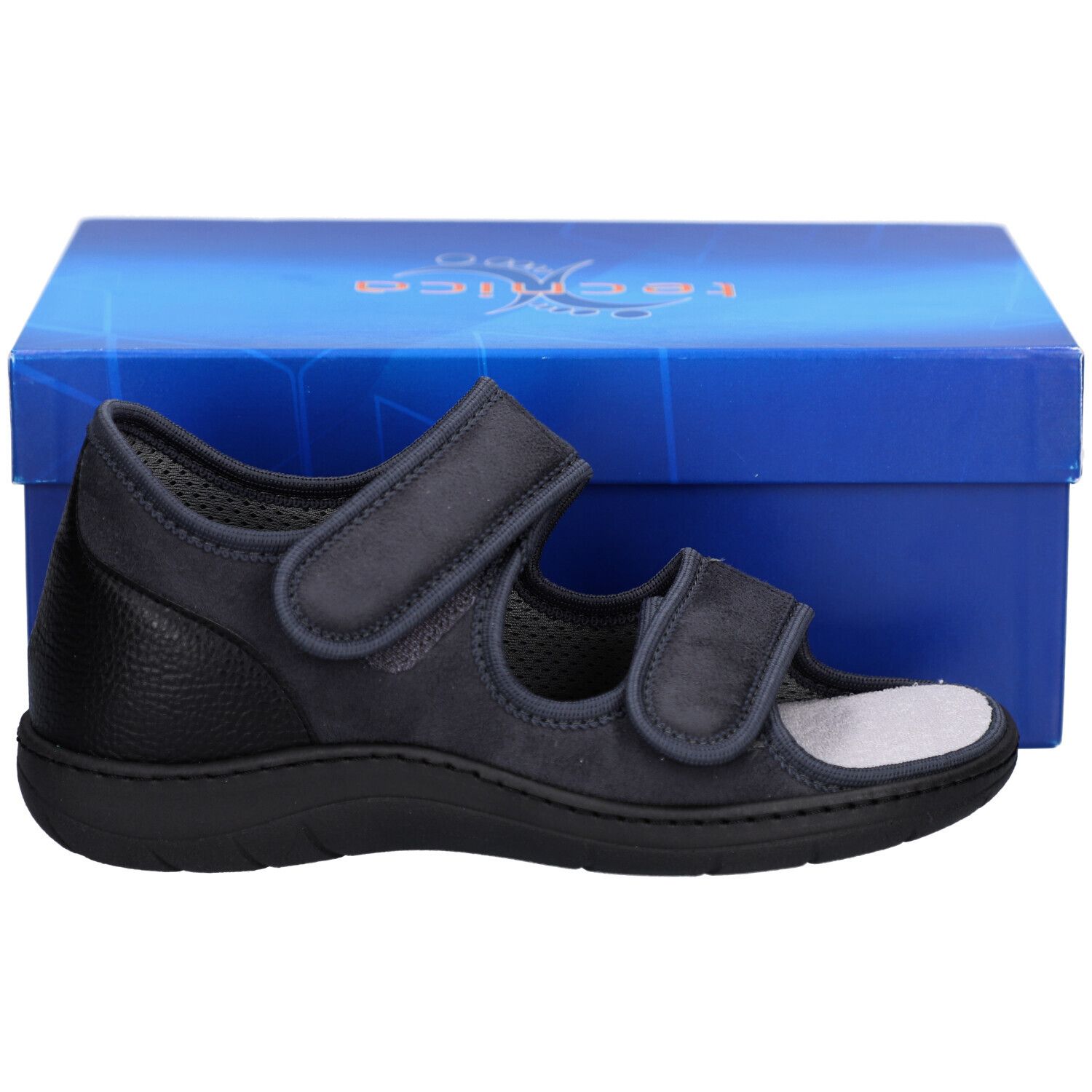 Chaussure grise avec fermetures velcro et semelle noire. Taille 38 visible. Devant une boîte bleue.