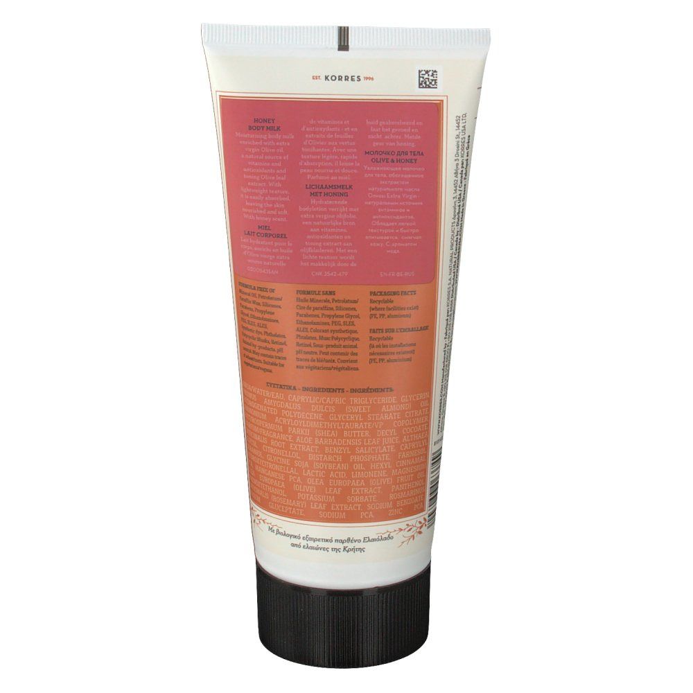 Achterkant van de tube. Tekst in meerdere talen. Roze en beige kleurvlakken. Zwarte dop.