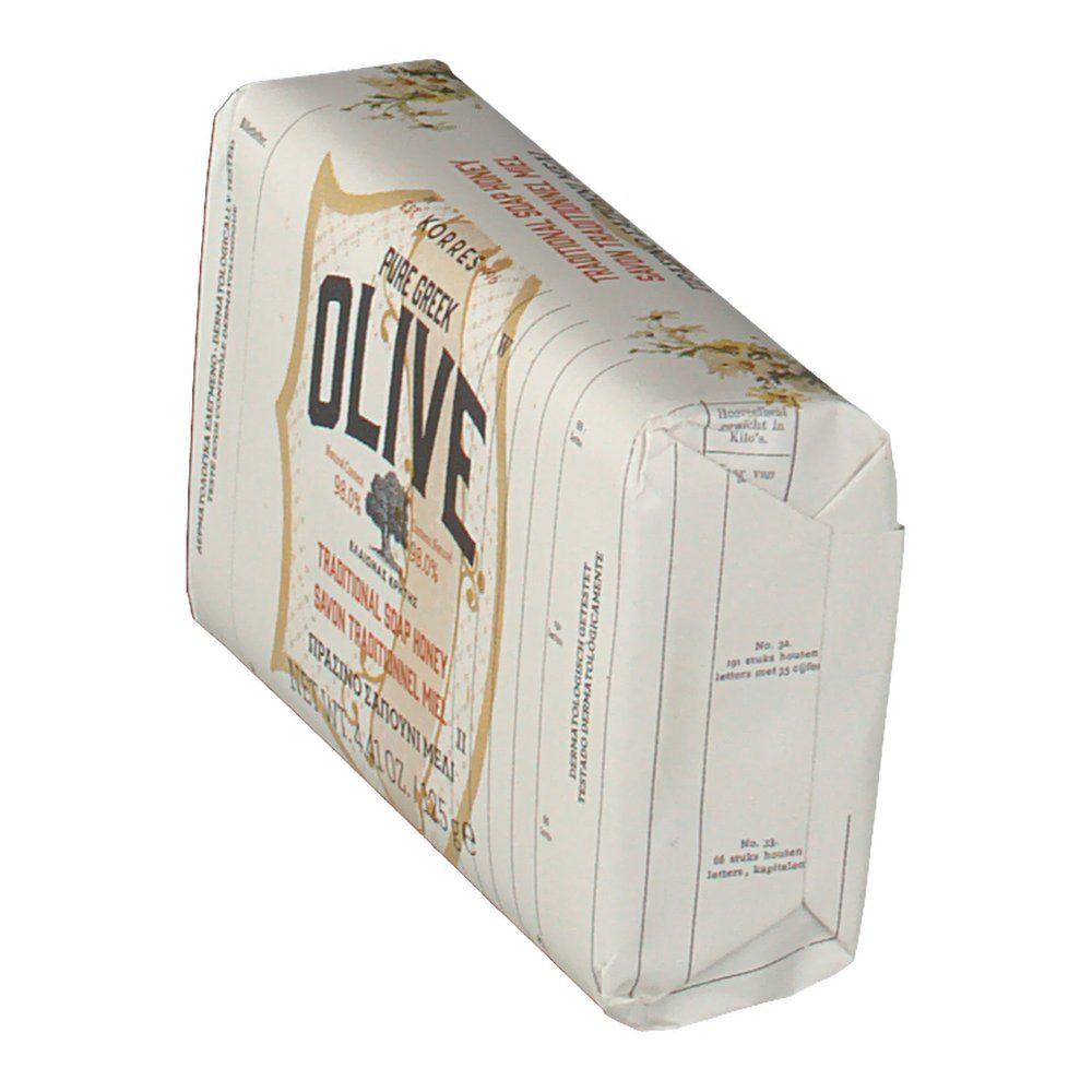 Savon incliné dans son emballage. Inscription OLIVE, marque Korres. Texte multilingue.